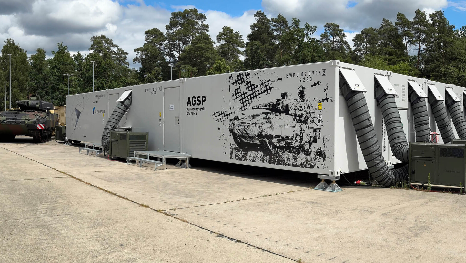 Infantry Fighting Vehicle Puma beside Rheinmetall's mechanized vehicle simulator