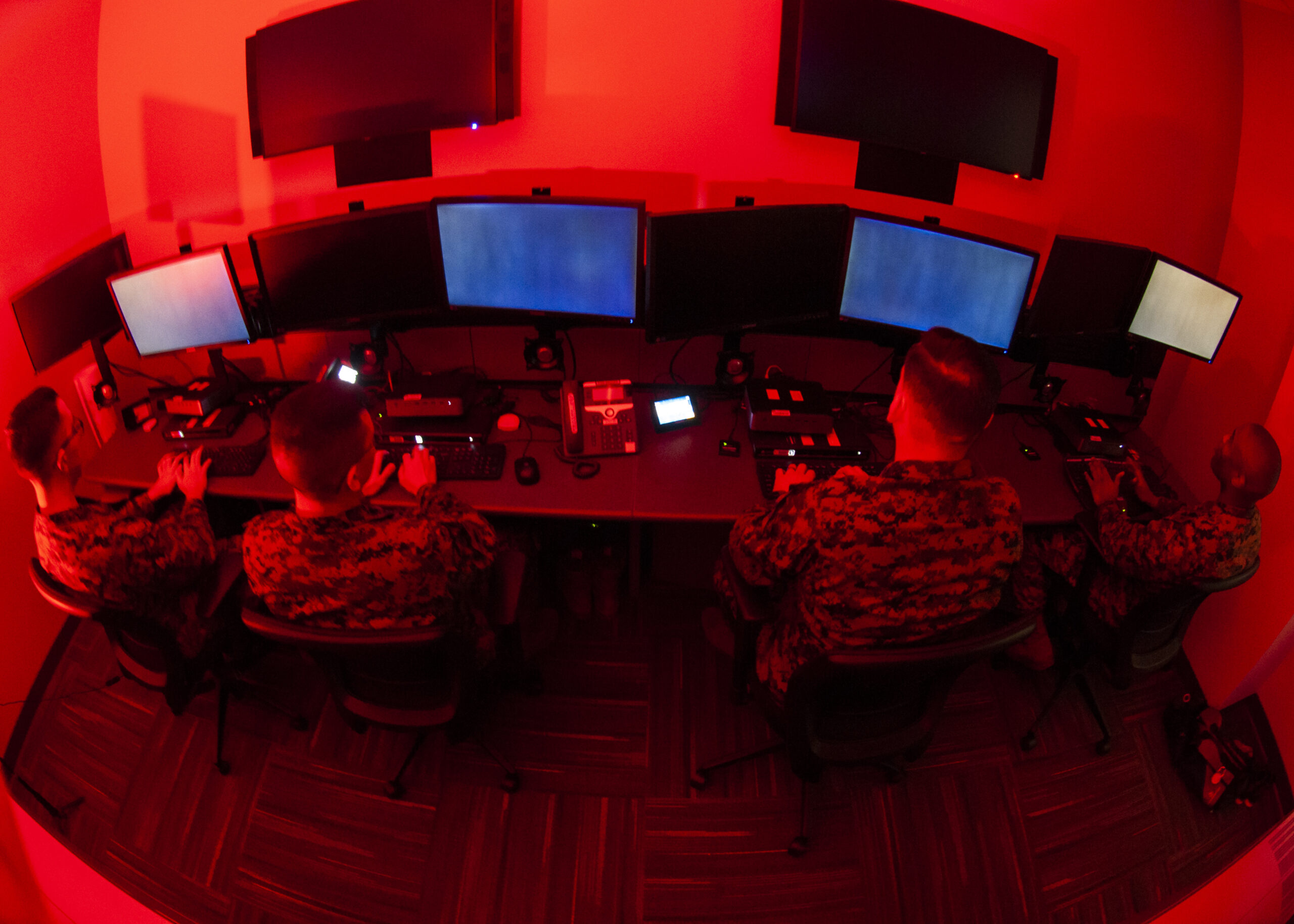 Marines with Marine Corps Forces Cyberspace Command pose for photos in cyber operations room at Lasswell Hall aboard Fort Meade, Maryland, Feb. 5, 2020. MARFORCYBER Marines conduct offensive and defensive cyber operations in support of United States Cyber Command and operate, secure and defend the Marine Corps Enterprise Network. This image is a photo illustration.