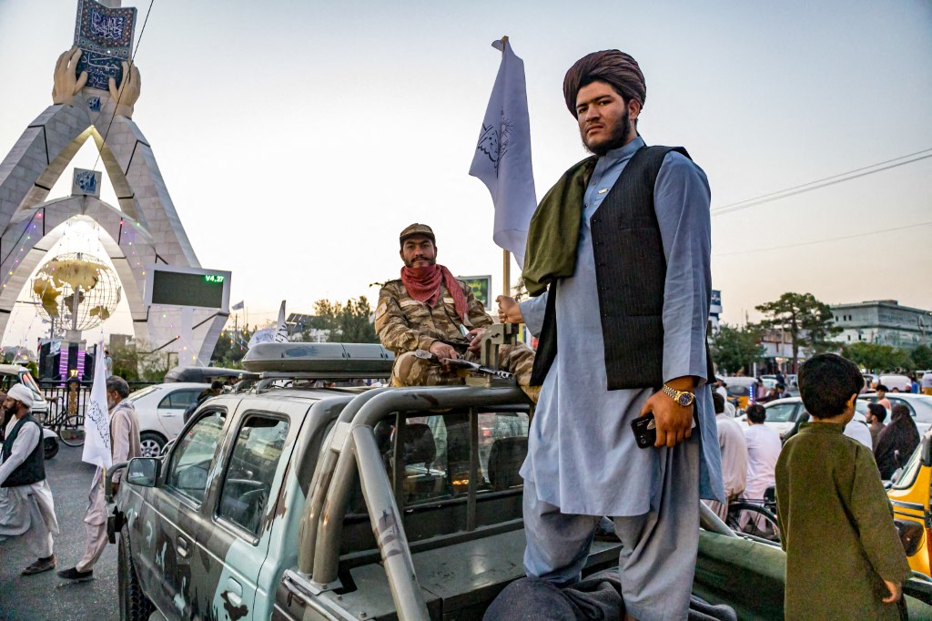 Taliban personnel riding a car in Afghanistan