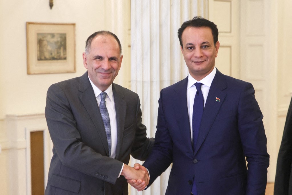 Meeting of Greece's Foreign Minister George Gerapetritis with Belgacem Haftar, son of Khalifa Haftar, while shaking hands