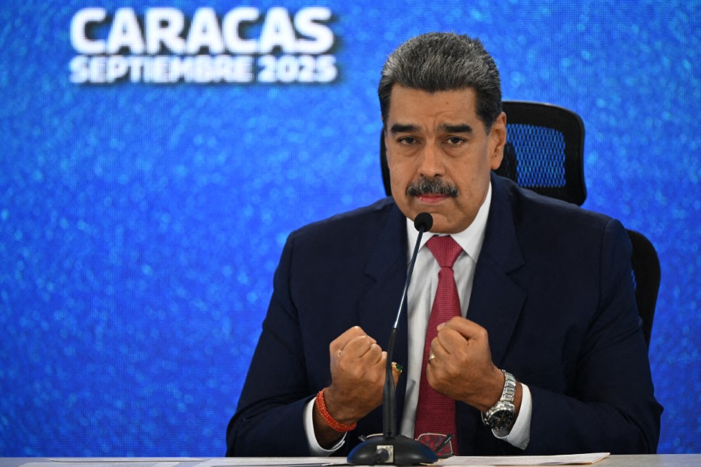 Venezuelan President Nicolas Maduro addressing a press conference while in front of blue screen