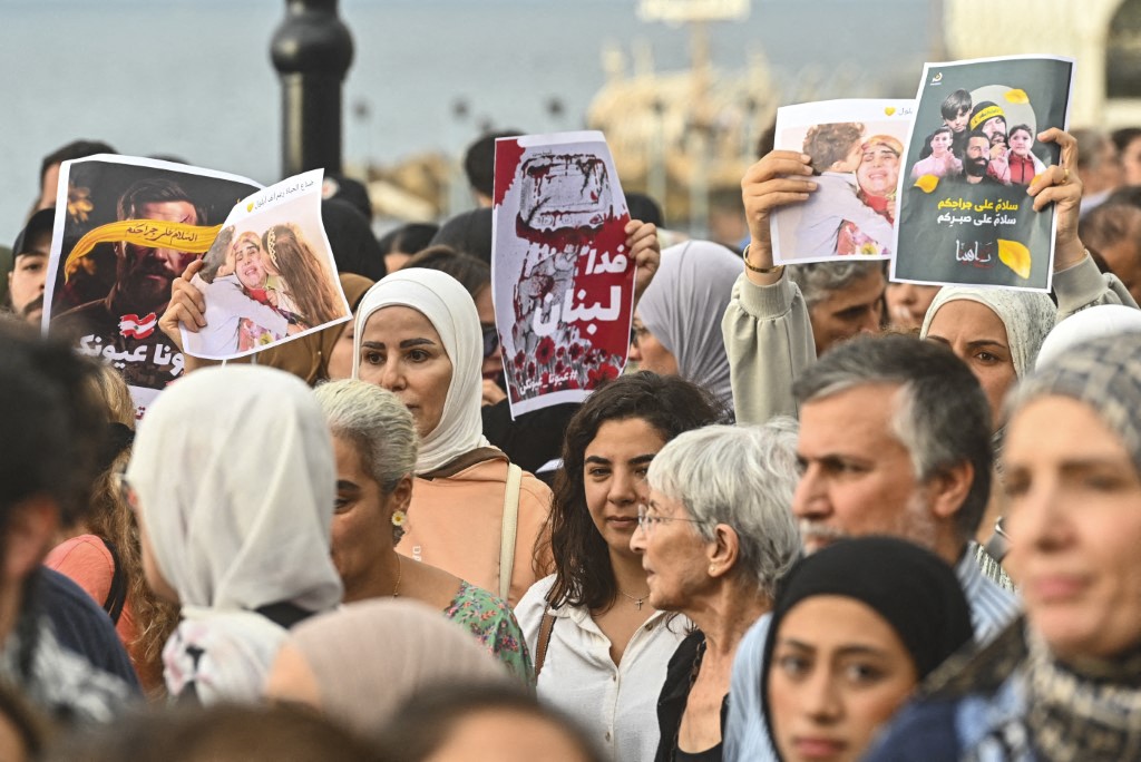 Lebanon residents holding up protest signs in the country