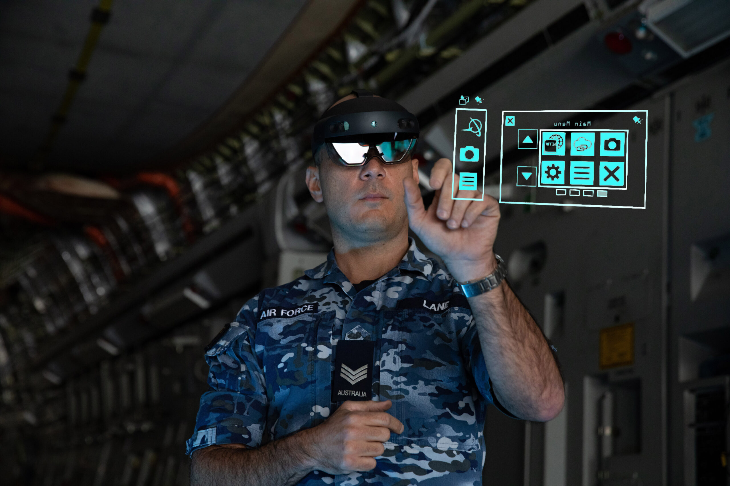 Avionics Technician, Sergeant Thomas Lane from No. 36 Squadron, utilises the Hololens mixed reality device during maintenance of a C-17A Globemaster III aircraft. Digitally Altered Image. *** Local Caption *** Aircraft Technicians from No. 36 Squadron at RAAF Base Amberley are now using Microsoft HoloLens mixed reality devices (goggles) with Boeing software to maintain C-17A Globemaster III aircraft. Implemented by the Squadron and Boeing contractors to navigate COVID-19 restrictions when working with their United States based counterparts, the first trial of the devices started in July 2020. This is a new capability for any RAAF aircraft maintenance team.