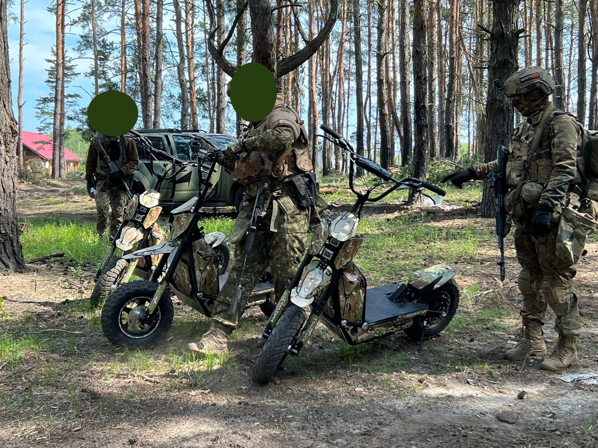 Ukrainian soldiers on Global Wolf Motors scooters