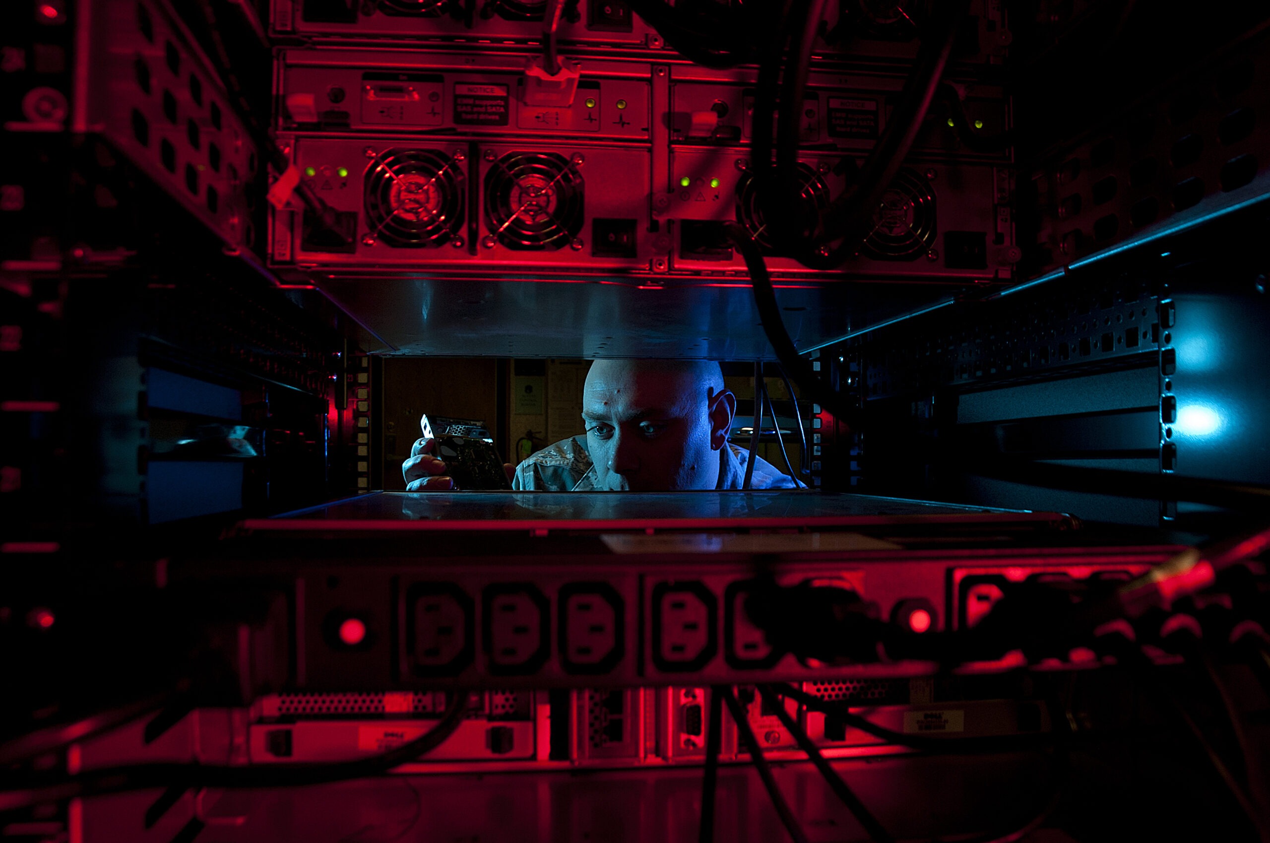 U.S. Air Force Staff Sgt. Jerome Duhan, 97th Communications Squadron network administrator, inserts a hard drive into a retina server inside the 97th network control center Jan. 24, 2014. The 97th Air Mobility Wing is scheduled to undergo its first phase three Command Cyber Readiness Inspection during the week of Jan. 27, 2014. Base members can assist by removing their common access cards from the computer the moment they walk away. (U.S. Air Force photo by Senior Airman Franklin R. Ramos/Released)