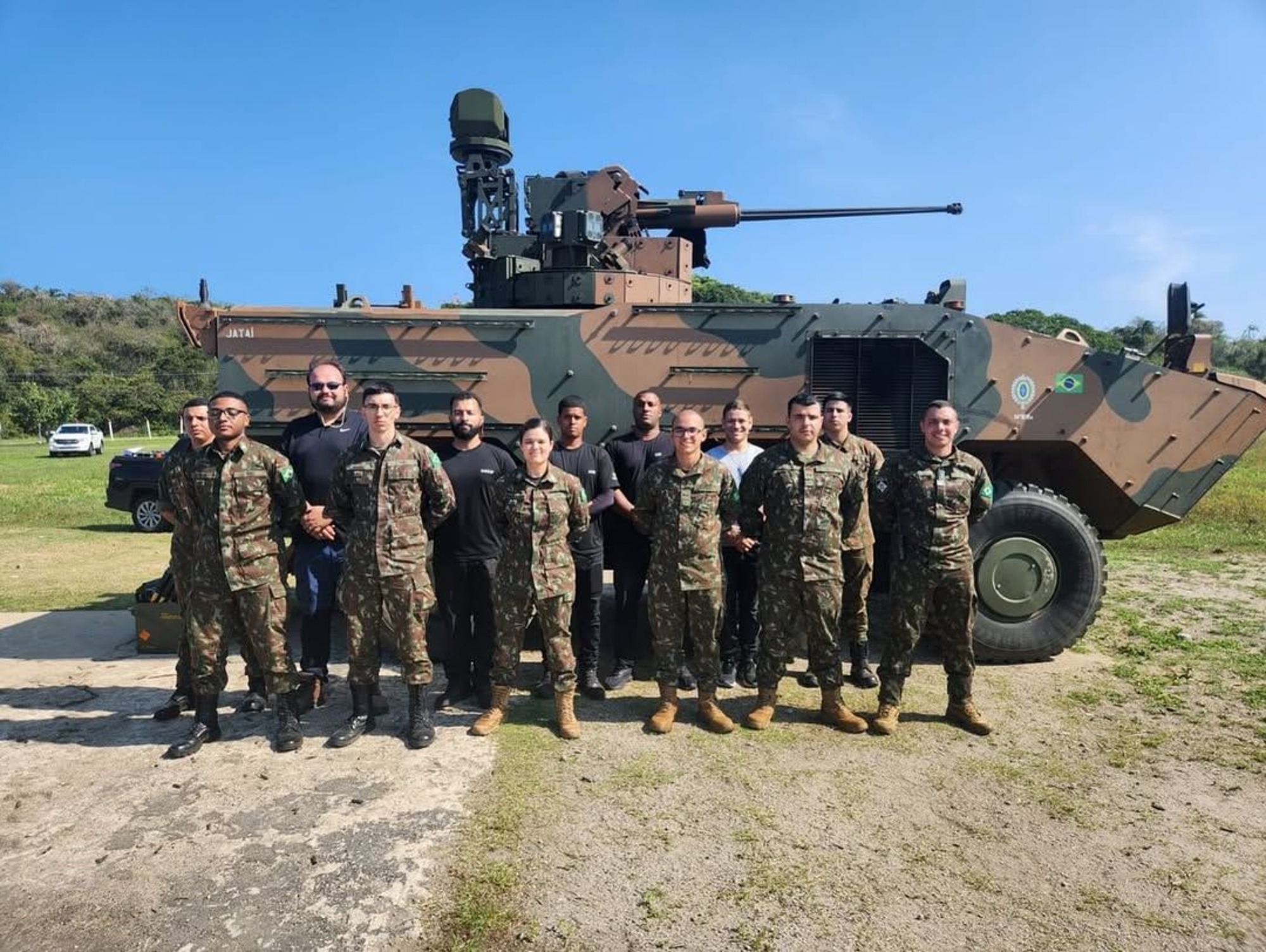 Brazilian Army and ARES personnel in front of a UT30BR-equipped Guarani armored personnel carrier