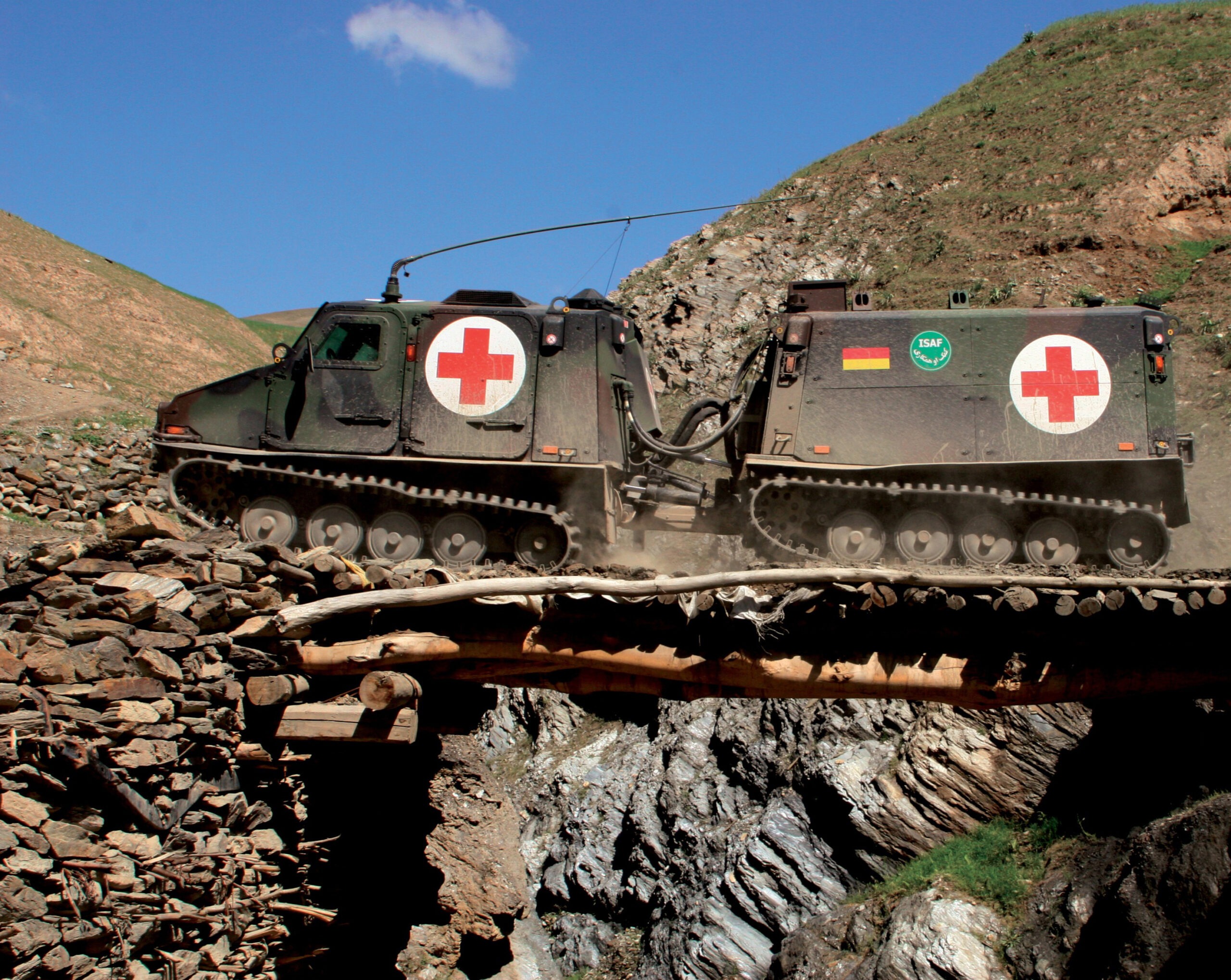 Command and transport vehicle BV 206 S (Husky /Hägglund) crosses a bridge in the mountains of Afghanistan.