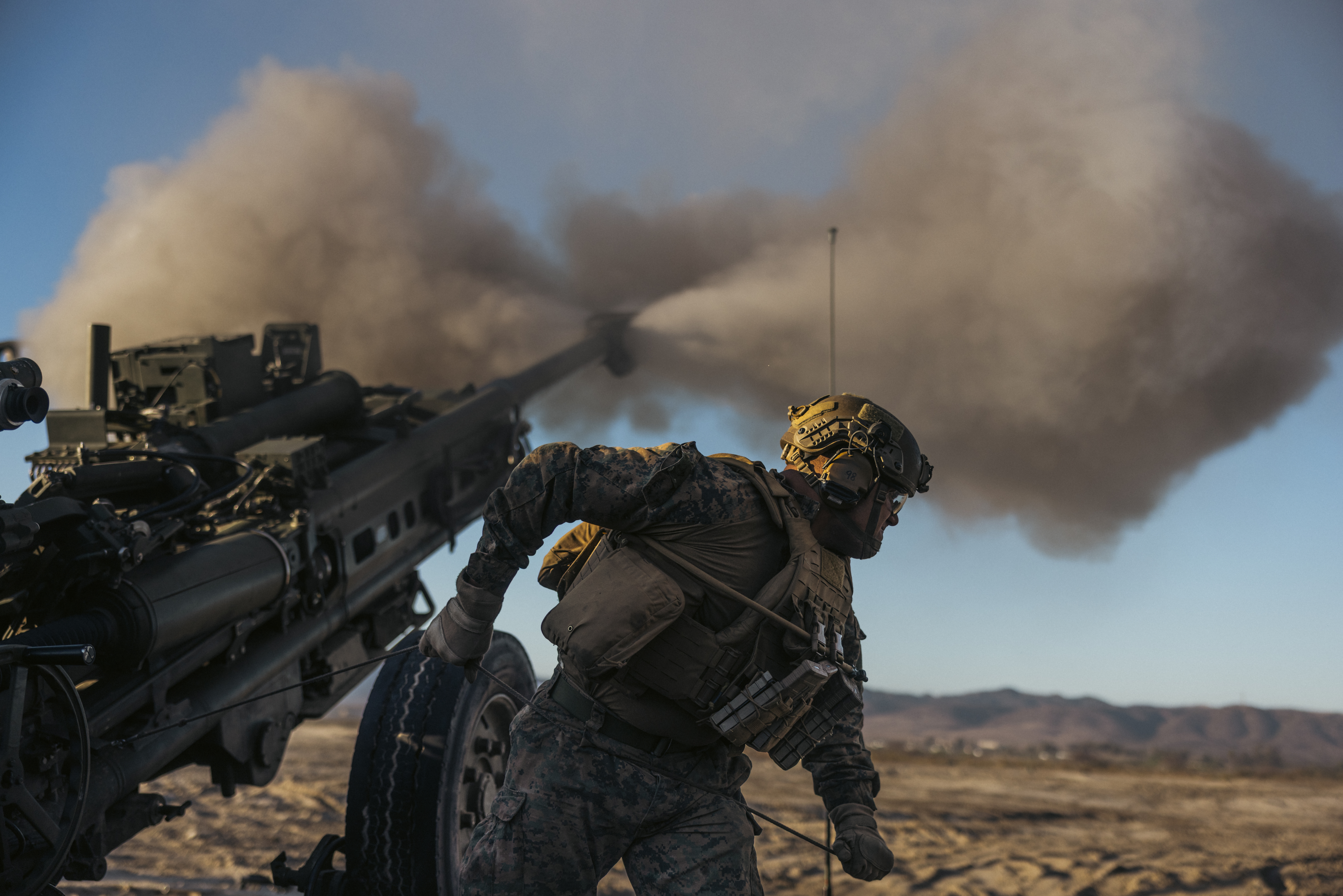 U.S. Marine Lance Cpl. Dashawn M. Rudesill, a cannoneer with 2nd Battalion, 11th Marine Regiment, 1st Marine Division, fires an M777 lightweight 155mm howitzer during a rehearsal for the 250th Amphibious Capabilities Demonstration at Red Beach combat town, Marine Corps Base Camp Pendleton, Oct. 17, 2025. The 250th Amphibious Capabilities Demonstration at Camp Pendleton marks the Marine Corps’ 250th birthday and America’s Semiquincentennial. The live-fire event highlights the Navy-Marine Corps team’s ability to integrate across air, land, and sea, showcasing the Corps’ enduring role as America’s force in-readiness. Rudesill is a native of Rushville, Illinois. (U.S. Marine Corps photo by Gunnery Sgt. Aaron S. Patterson)