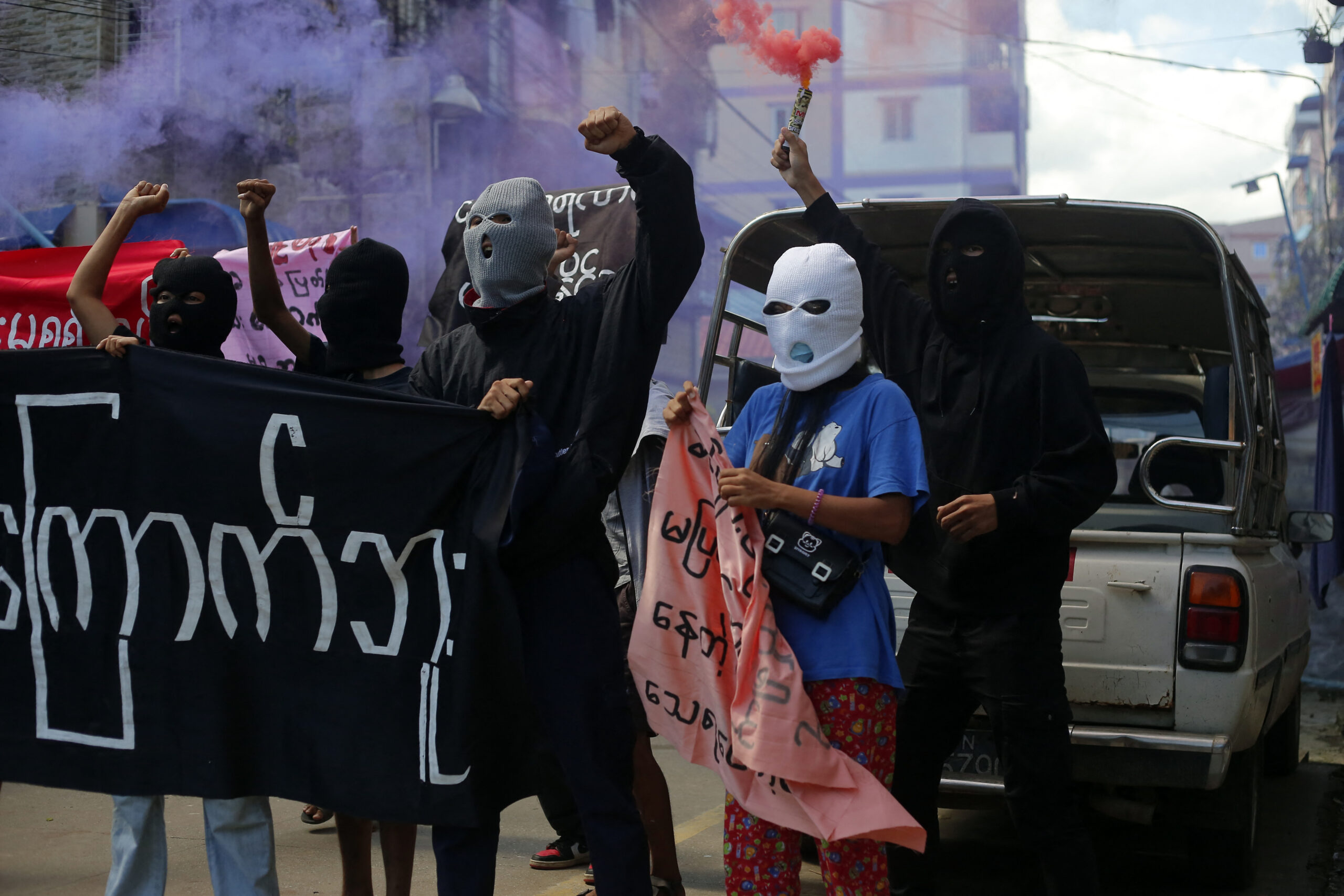 Young demonstrators shout slogans and hold flares during an anti-coup protest in Yangon, Myanmar on July 25, 2022. Myanmars military junta on July 25, 2022, reported the execution of four political prisoners in the countrys first death sentences carried out in over 30 years. (Photo by STR/NurPhoto) (Photo by NurPhoto via AFP)