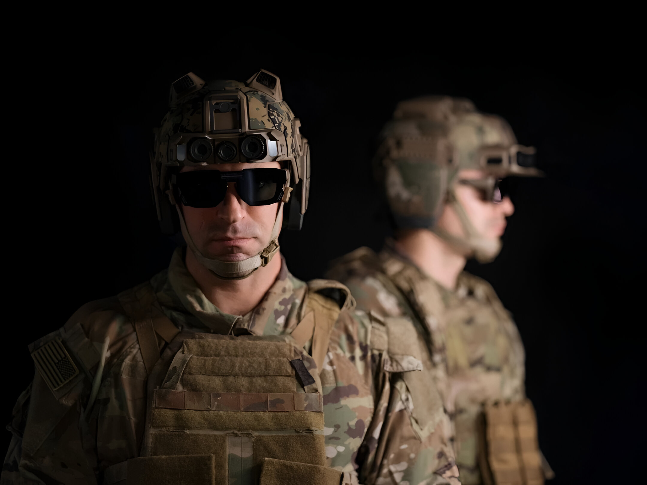 A soldier and his reflection shown wearing Anduril's EagleEye system against a black background