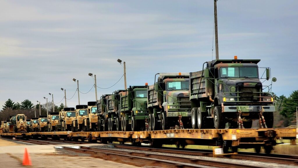 Military vehicles and equipment from the Army Reserve’s 411th Engineer Company sit secured on railcars at Fort McCoy, Wisconsin