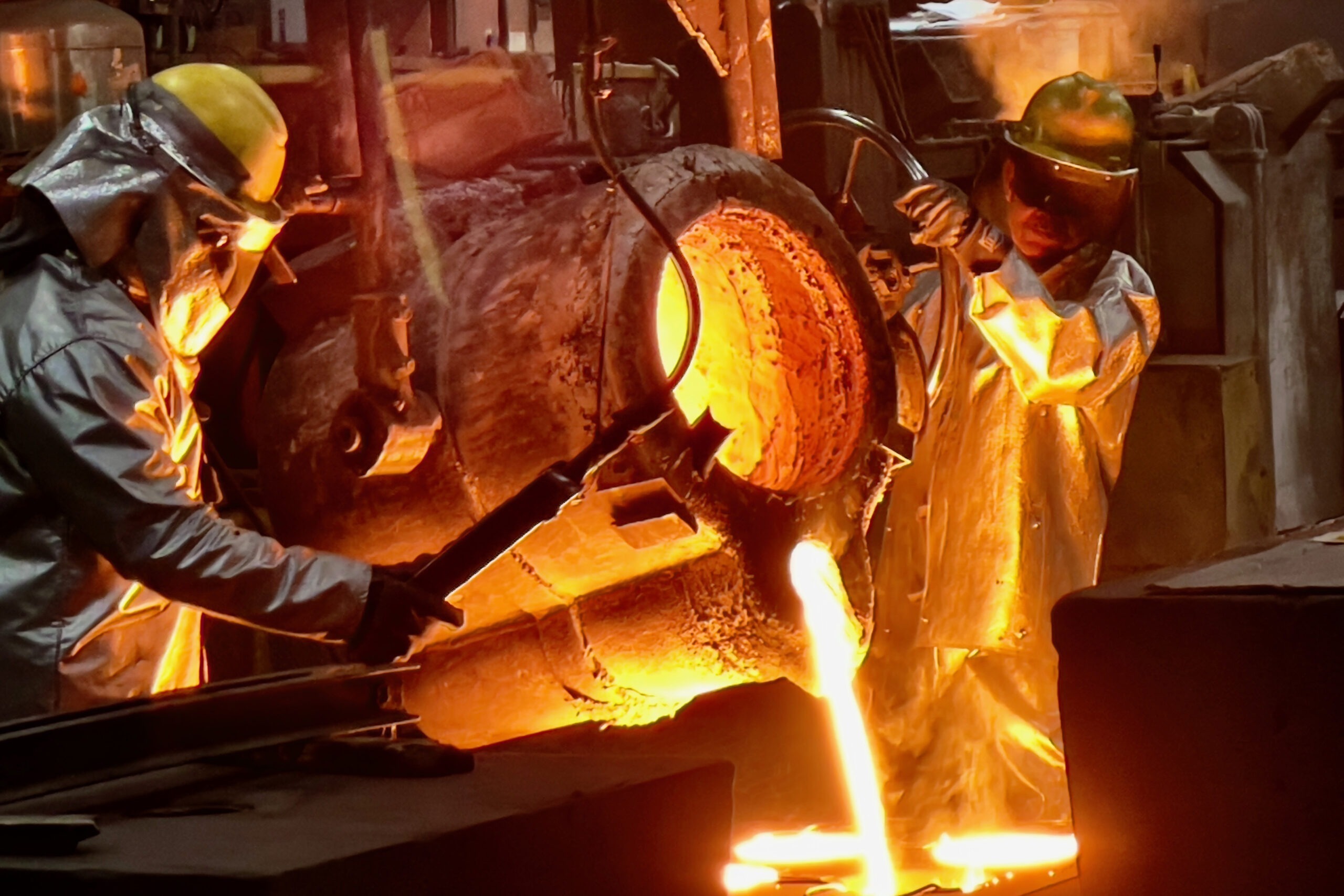 Foundry artisans fill a mold to manufacture cast parts at Stainless Foundry and Engineering in Wisconsin