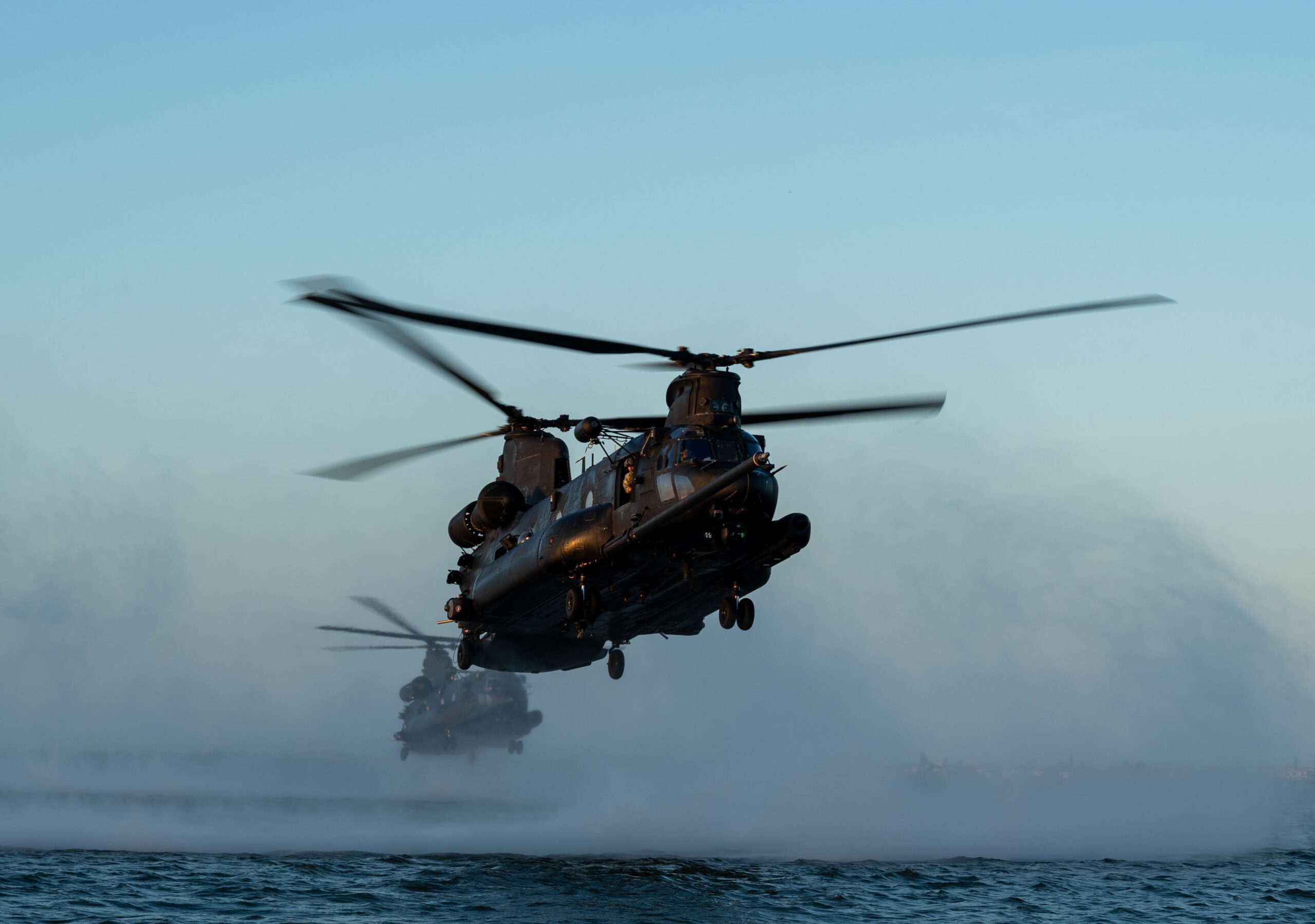 Two 160th Special Operations Aviation Regiment MH-47G Chinook helicopters hoover above Banana River, Florida, Feb. 15, 2023, during combat search and rescue training. The 160th SOAR's mission is to organize, equip, train, resource and employ Army special operations aviation forces worldwide in support of contingency missions and combatant commanders. (Staff Sgt. Darius Sostre-Miroir)