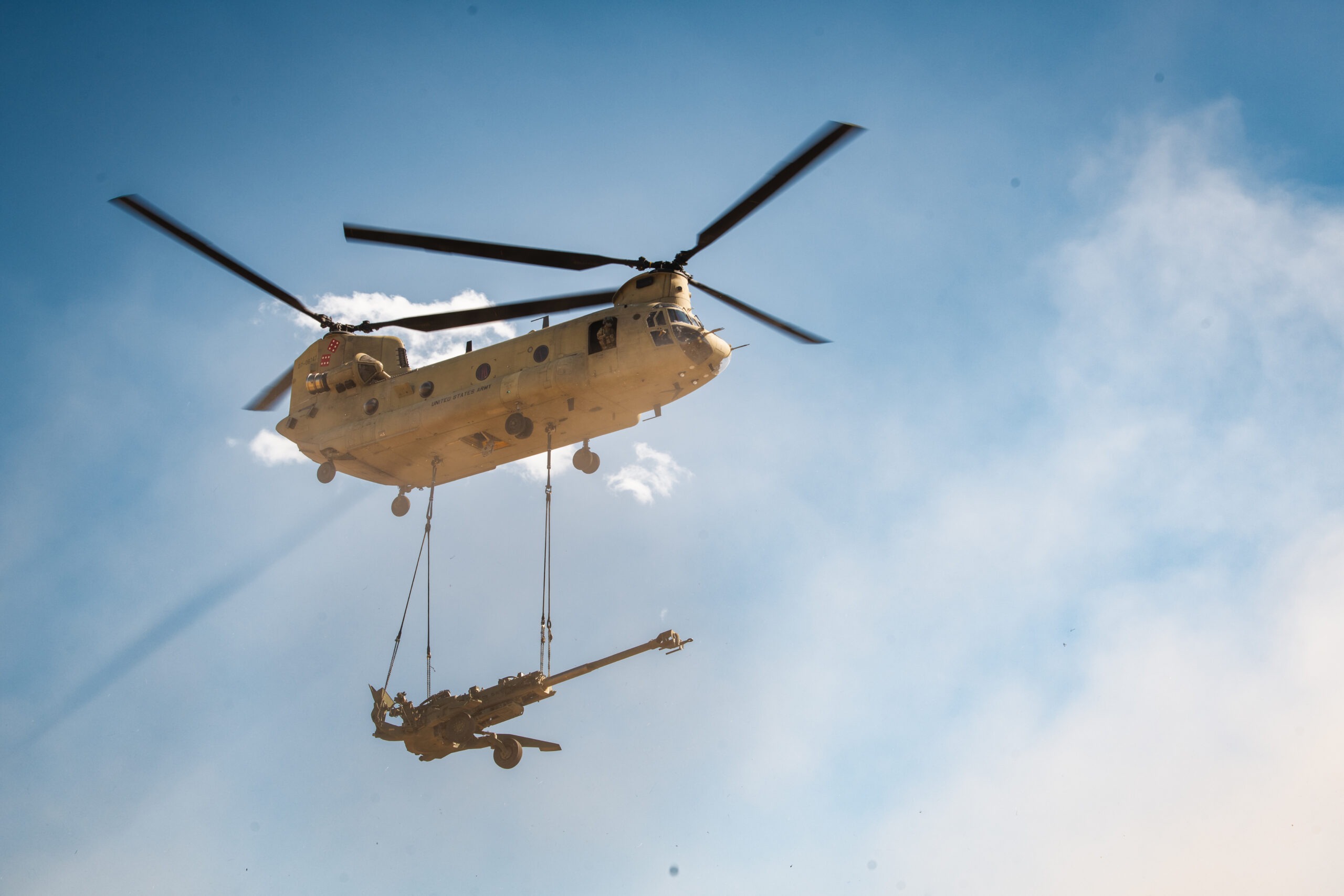A CH-47 Chinook helicopter with 1st Battalion, 168th Aviation (General Support), 96th Aviation Troop Command, Washington National Guard airlifts a M777 towed 155mm howitzer during a training exercise with 2nd Battalion, 146th Field Artillery Regiment, 81st Stryker Brigade Combat Team, Washington National Guard at Yakima Training Center, Wash., July 17, 2025. The 96th Aviation Battalion’s CH-47 helicopters have the ability to slingload cargo from their undercarriage, including the M777 towed 155mm howitzer artillery cannons. (U.S. Army National Guard photo by Spc. Tristin Salisbury)