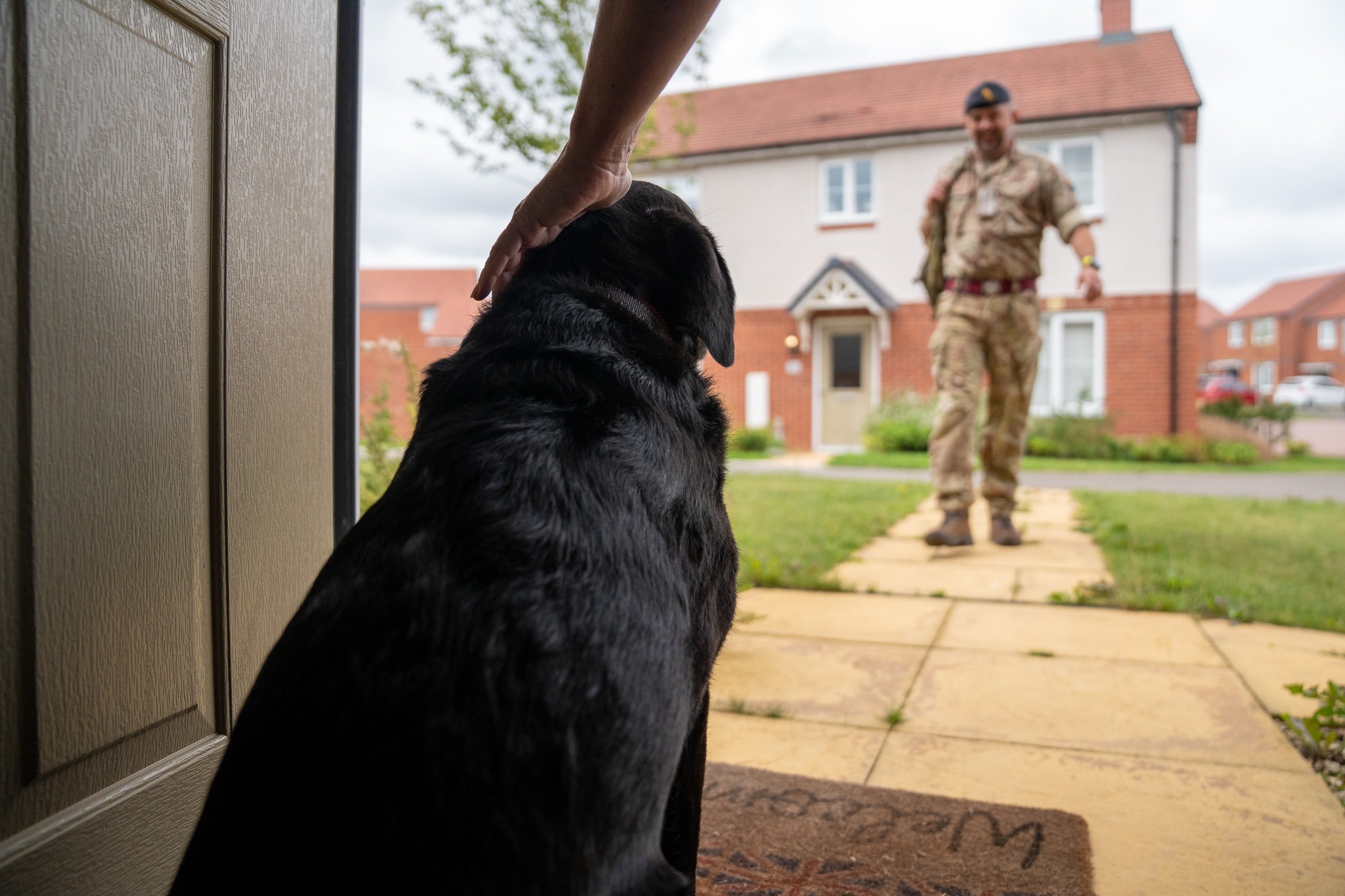 Image of a Service member, seen here coming home to the family dog Luna, at their Service Family Accommodation (SFA) in Whittington Barracks, Lichfield. Thousands of Armed Forces families will benefit from new freedoms to keep pets and personalise their homes as part of the Government’s commitment to improve forces housing. The measures, announced today include greater freedoms to own pets, decorate, and personalise houses, and run businesses from home.   The latest improvements to military family housing — some already in effect from 9 August — mark a key milestone in delivering the Government’s new Consumer Charter. Defence Secretary John Healey has pledged to put forces families at the heart of defence housing reform, vowing to “stop the rot” and raise standards across service accommodation nationwide. The Charter is part of the forthcoming Defence Housing Strategy, which will set out plans for a generational renewal of forces housing, helping renew the nation’s contract with those who serve and supporting the Government’s Plan for Change.  