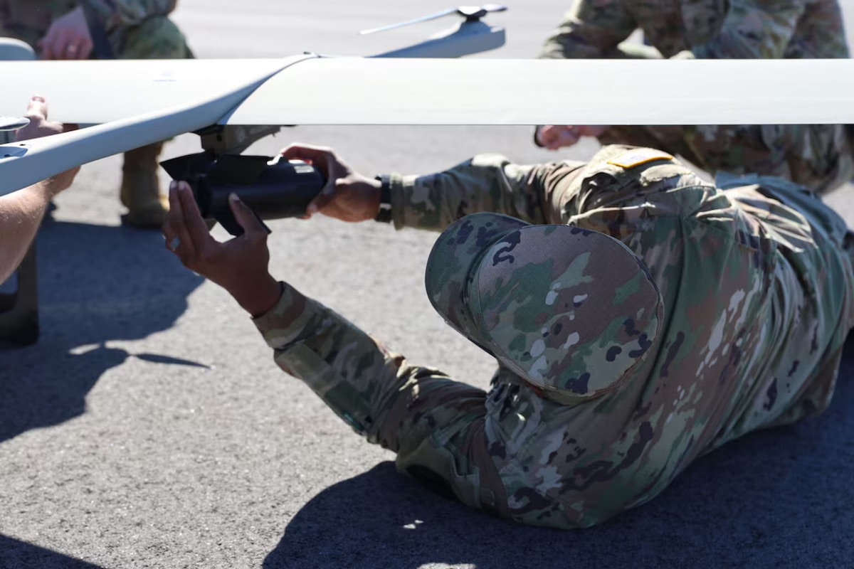 Army Sgt. Joshua Capers, assigned to the 1st Aviation Brigade of the Army Aviation Center of Excellence, attaches a payload to the VXE30 Stalker during training with an uncrewed aircraft system at Fort Rucker, Ala., Nov. 18, 2025.