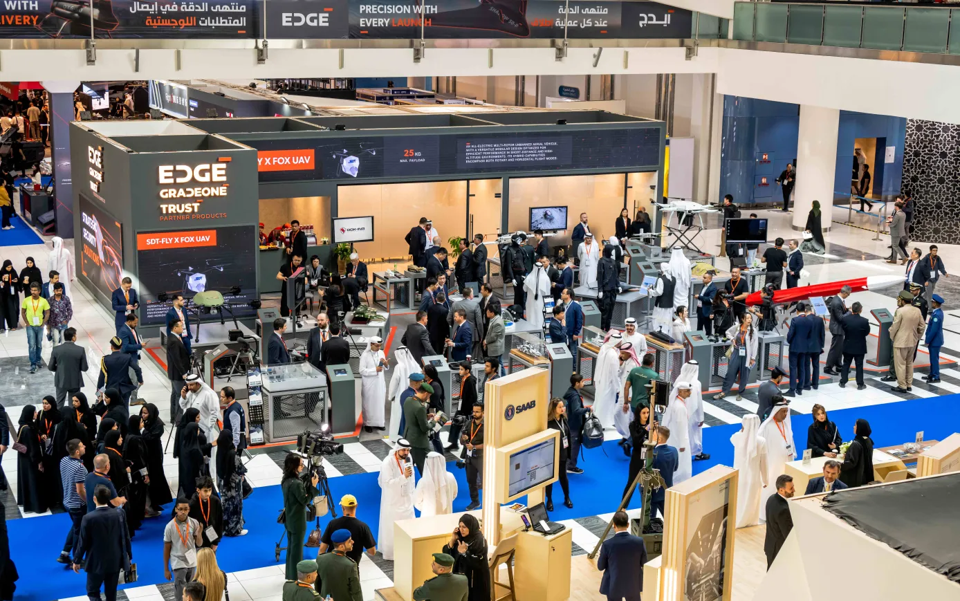 Visitors gather around the EDGE Group exhibition booth at a defense technology event showcasing drones and UAV systems