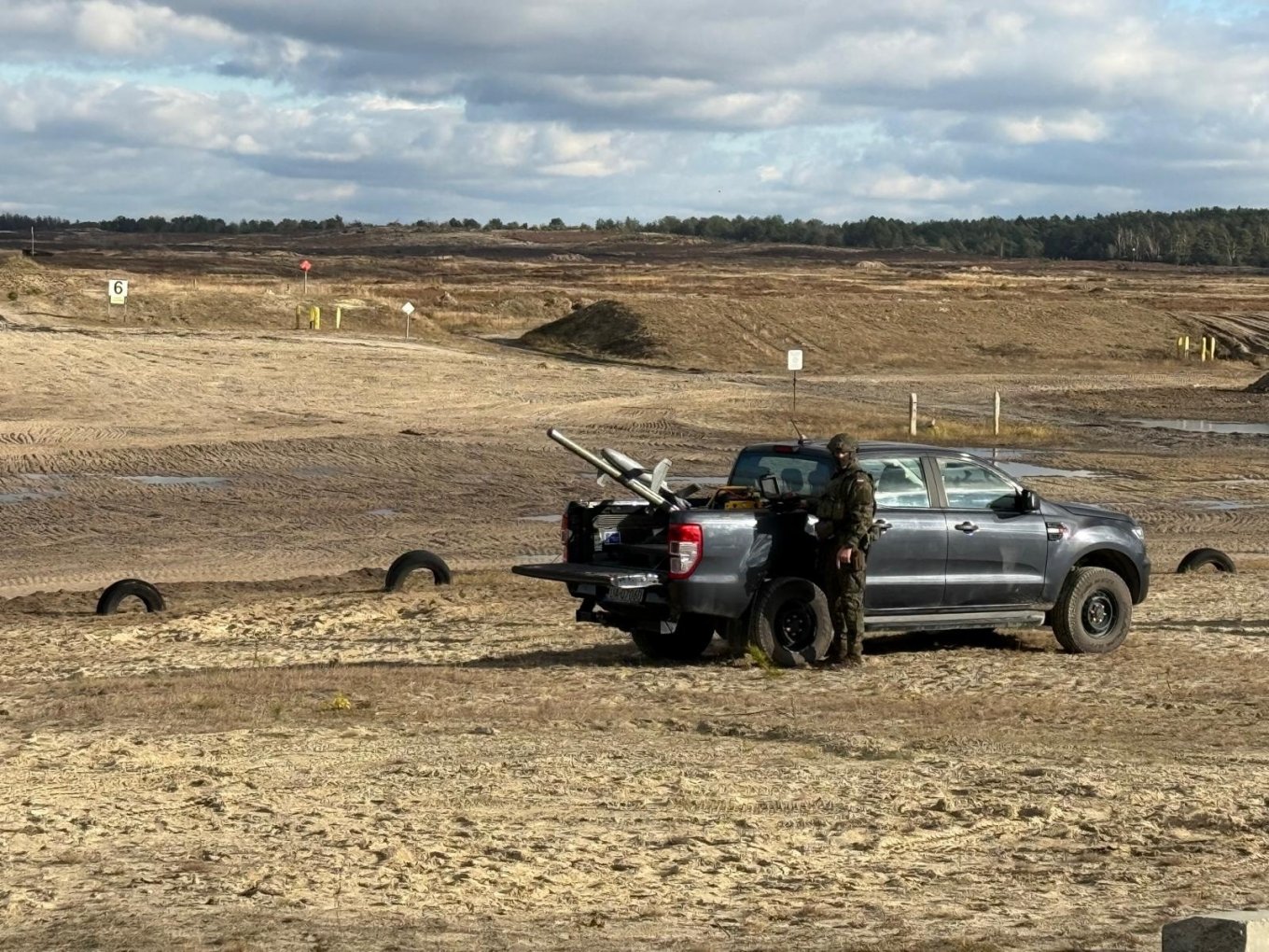 The Merops counter-drone system placed on a black truck bed with a soldier operating it.