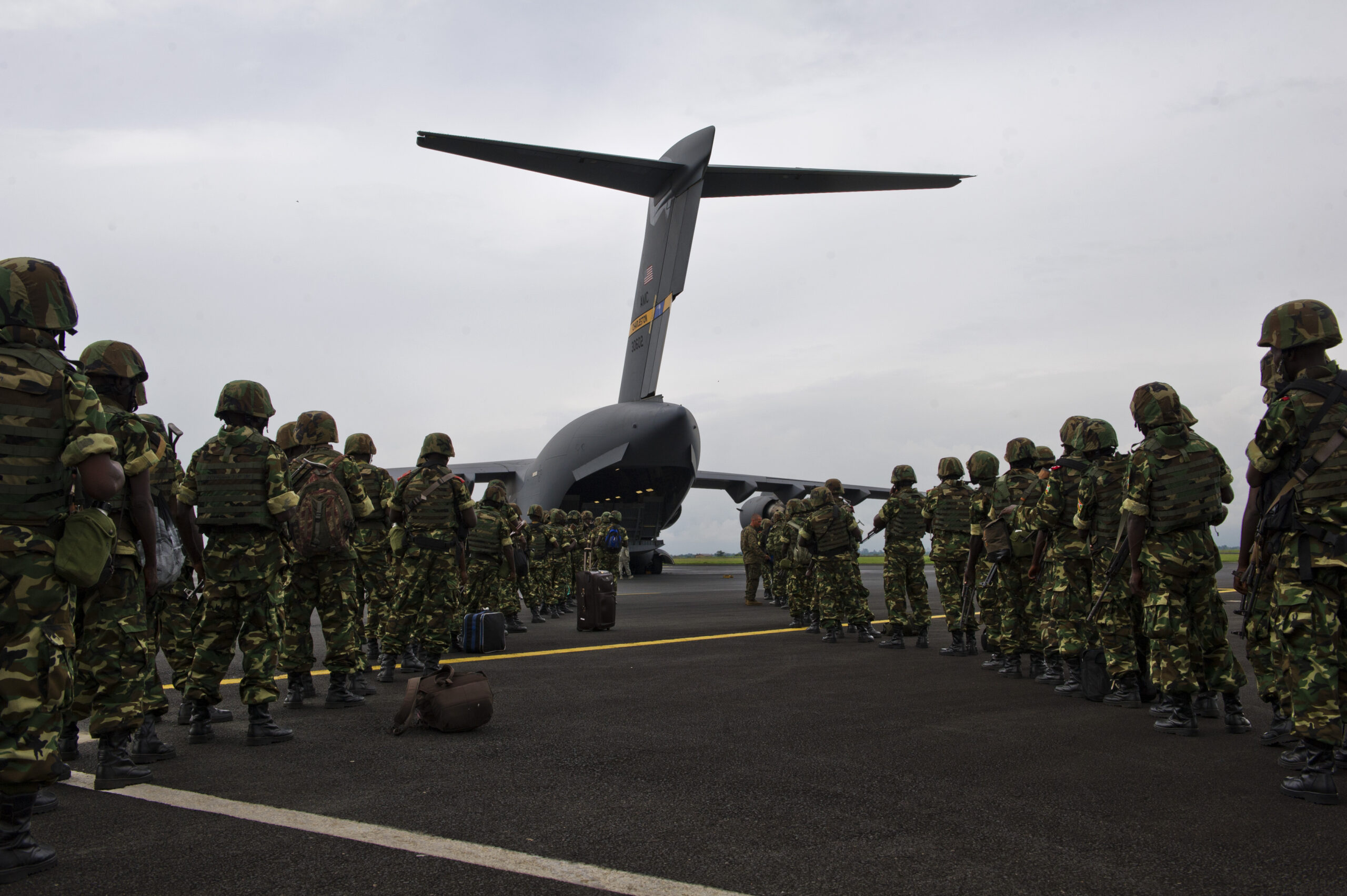 Burundian soldiers prepare to load onto a U.S. Air Force C-17 Globemaster III aircraft at Bujmumbura International Airport in Burundi Dec. 13, 2013. U.S. military aircraft were dispatched to transport Burundian forces to Bangui, Central African Republic, in support of an African Union effort to quell violence there. (U.S. Air Force photo by Staff Sgt. Erik Cardenas/Released)