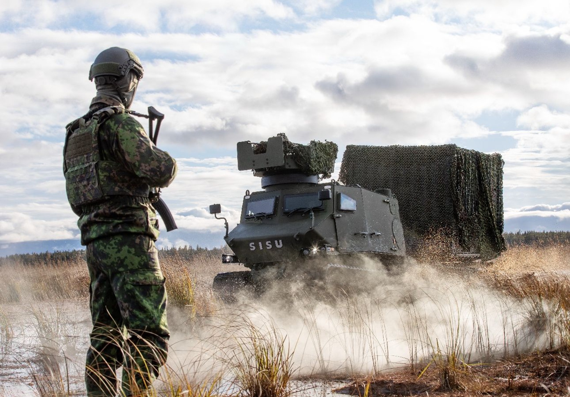 Soldier in front of a GTT all-terrain vehicle