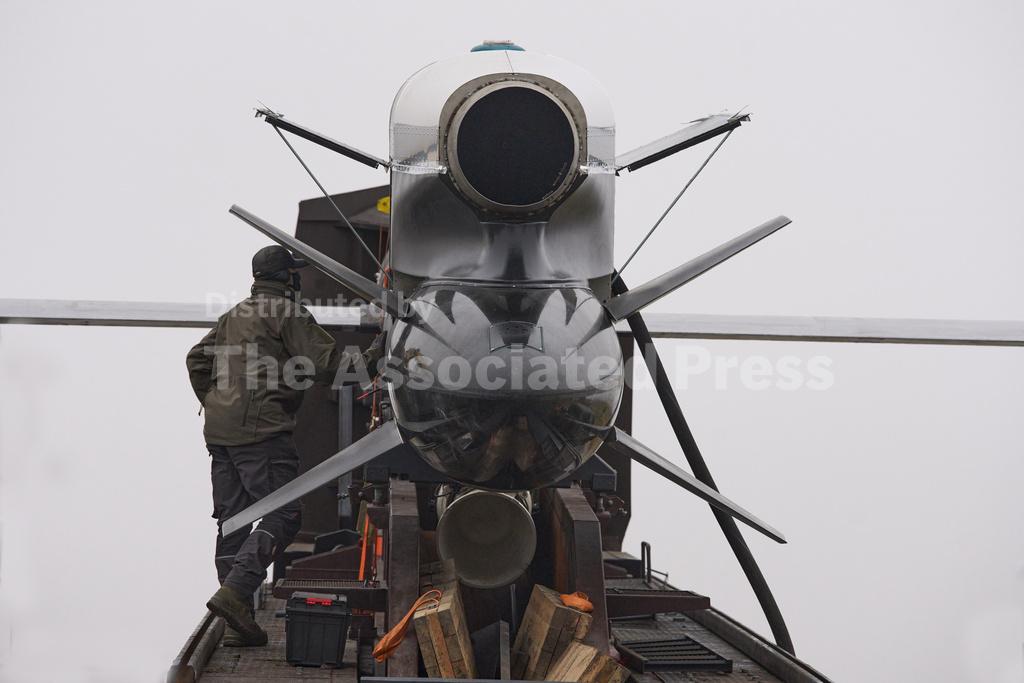 Workers and military inspect Ukrainian Fire Point's Flamingo missiles during handover to the military in an undisclosed location in Ukraine Thursday, Dec. 4, 2025. (AP Photo/Efrem Lukatsky)