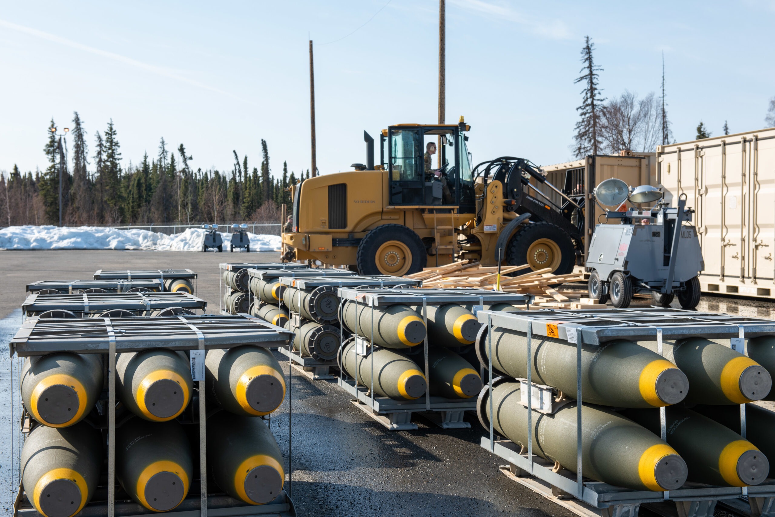 U.S. Airmen with the 3rd Munitions Squadron offload BLU-111 munitions from a shipping container at Joint Base Elmendorf-Richardson, Alaska, April 12, 2022. Over the course of eight days, the 3rd MUNS received the largest barge operation for the Air Force totaling 150,000 pounds of explosive weight. This is the 3rd MUNS annual inventory restock of both training and real-world munitions. (U.S. Air Force photo by Senior Airman Samuel Colvin)