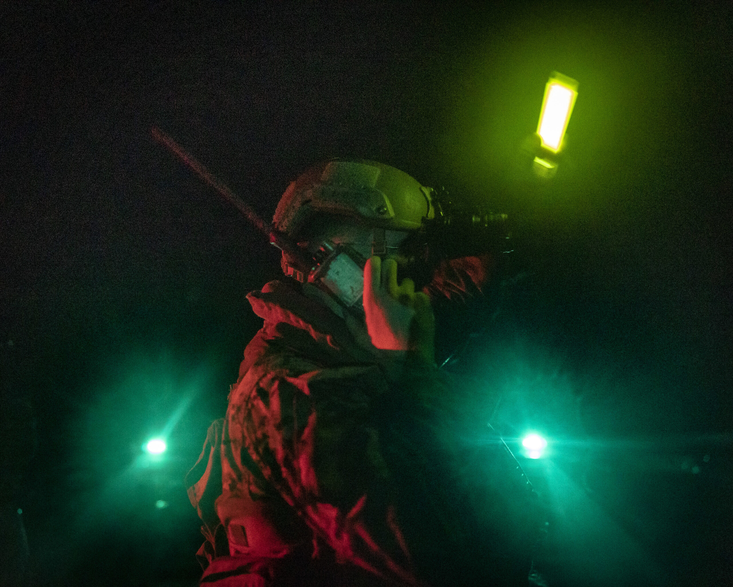 A U.S. Marine with Battalion Landing Team 2/5, 31st Marine Expeditionary Unit, listens to a radio and signals during a night casualty evacuation exercise aboard USS New Orleans (LPD 18) in the Sea of Japan, Sept. 12, 2022. The 31st MEU is operating aboard ships of the Tripoli Amphibious Ready Group in the 7th fleet area of operations to enhance interoperability with allies and partners and serve as a ready response force to defend peace and stability in the Indo-Pacific Region. (U.S. Marine Corps photo by Sgt. Danny Gonzalez)