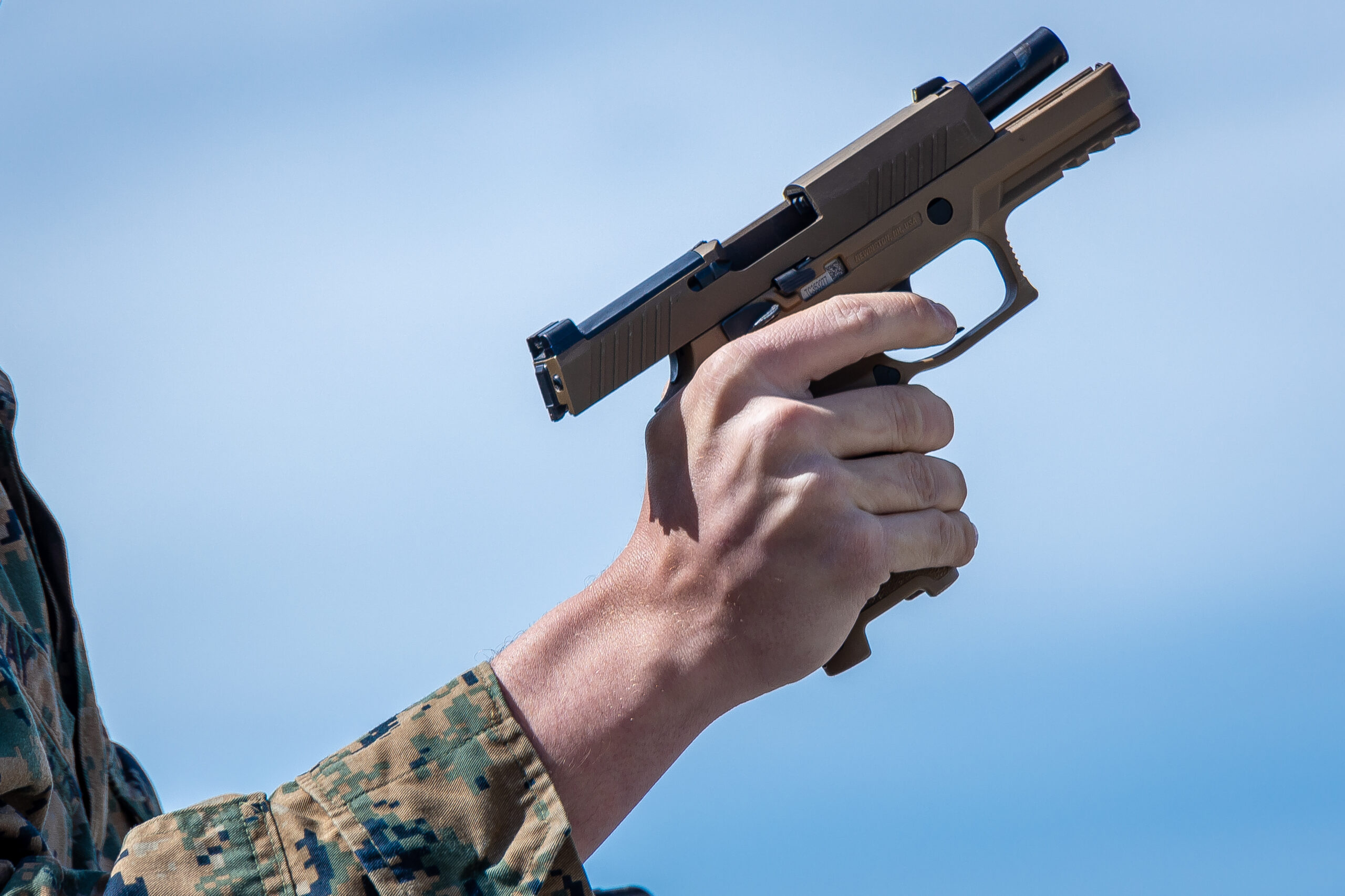 A U.S. Marine clears a P320-M18 Sig Sauer during the Marine Corps Marksmanship Competition West (MCMC-West) at Range 214 on Marine Corps Base Camp Pendleton, California, Feb. 21, 2023. MCMC-West provides an opportunity to refine the fundamental skills that make a Marine lethal on the battlefield and able to deliver lethal force in a dynamic environment. (U.S. Marine Corps photo by Lance Cpl. Mhecaela J. Watts)