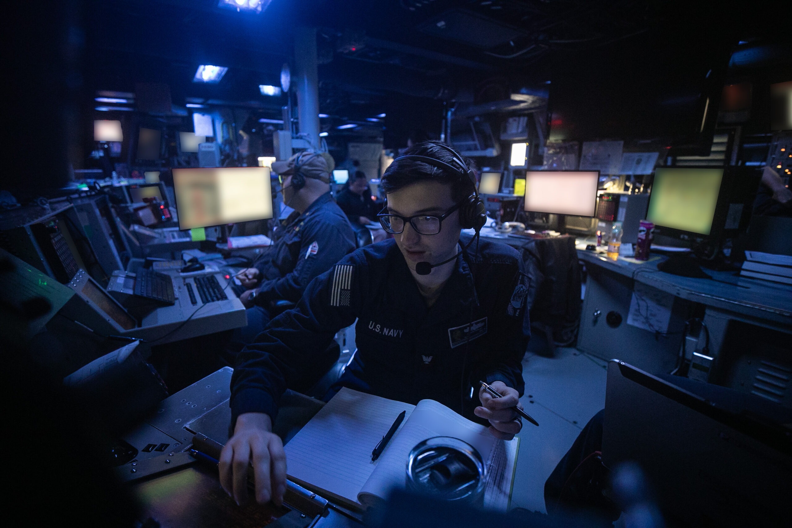 250531-N-VM650-1018 U.S. CENTRAL COMMAND AREA OF RESPONSIBILITY (May 31, 2025) U.S. Sailors stand watch in the combat information center aboard the Arleigh Burke-class guided-missile destroyer USS Wayne E. Meyer (DDG 108) in the U.S. Central Command area of responsibility. (Official U.S. Navy photo) (This photo has been altered by blurring screens and documents for security purposes)