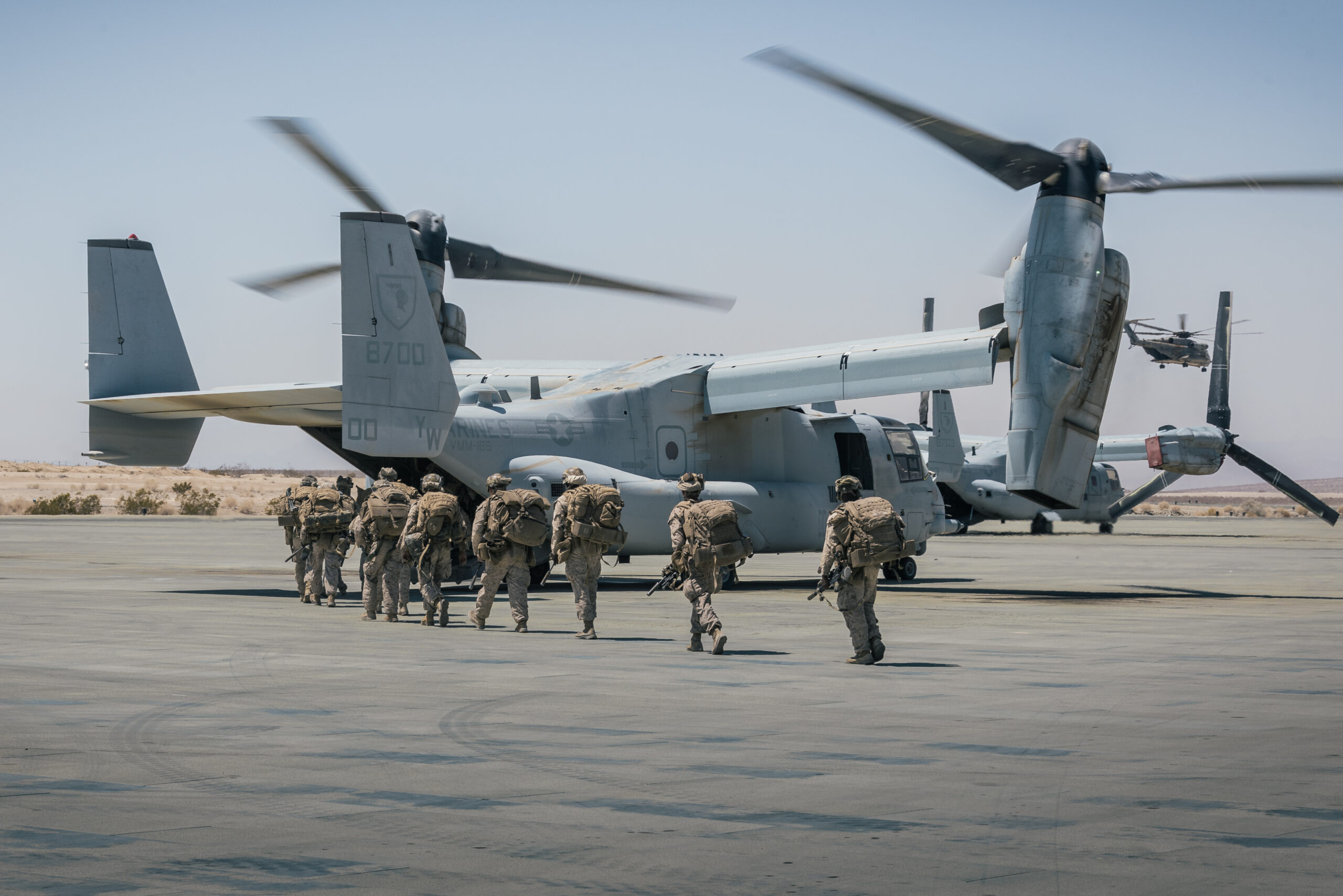 U.S. Marines with 2nd Battalion, 8th Marine Regiment, 2nd Marine Division, board an MV-22B Osprey assigned to Marine Medium Tiltrotor Squadron (VMM) 165, Marine Aircraft Group 16, 3rd Marine Aircraft Wing, during Service Level Training Exercise 4-25 at Marine Corps Air-Ground Combat Center, Twentynine Palms, California, Aug. 13, 2025. SLTE 4-25 is designed to be a challenging, realistic training environment that produces combat-ready forces capable of operating as an integrated Marine Air-Ground Task Force across all domains of military operations. (U.S. Marine Corps photo by Lance Cpl. Alexis Ibarra)