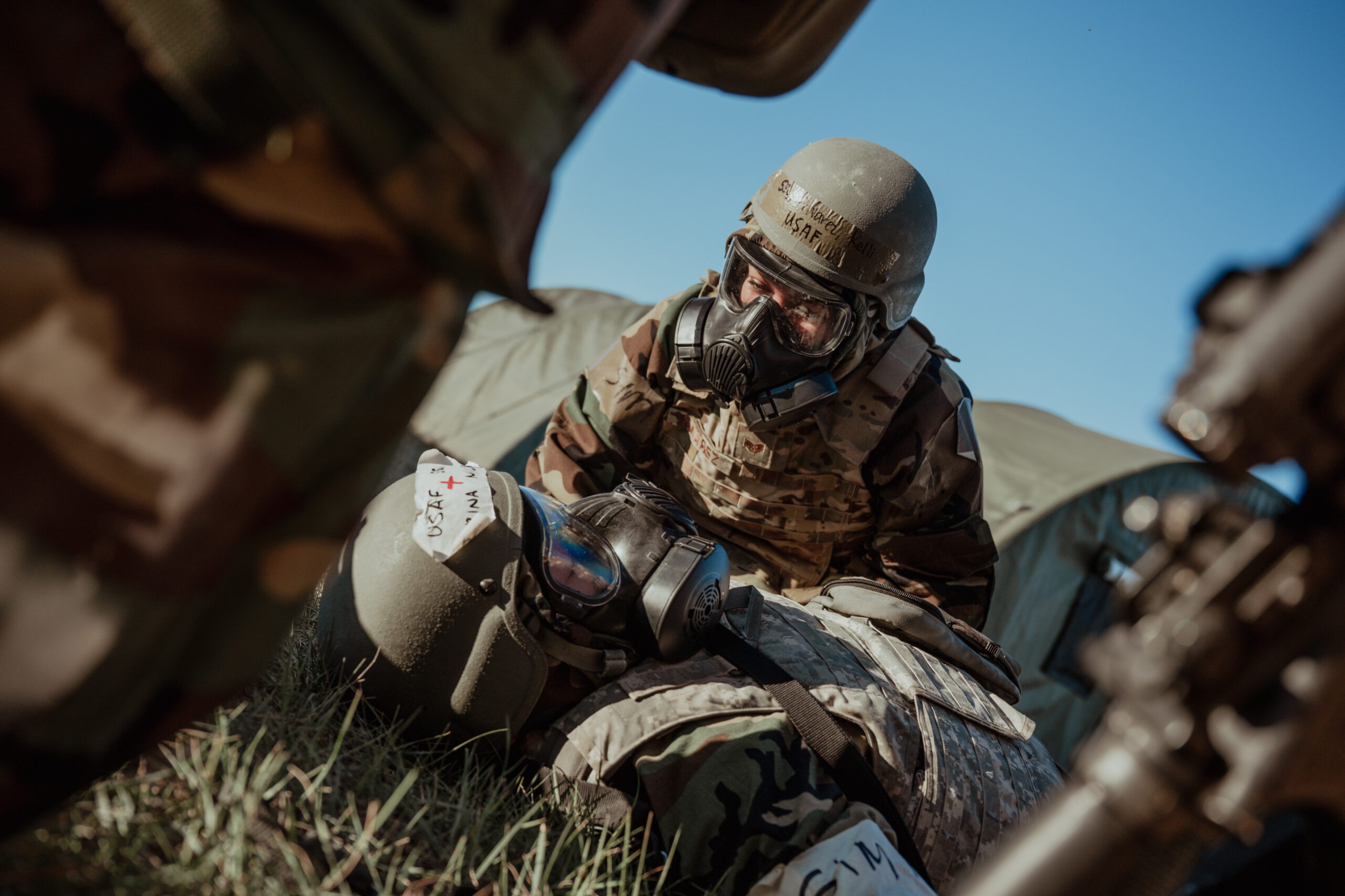 Staff Sgt. Kelli Alvarez, the supply non-commissioned officer in charge of the 819th Rapid Engineer Deployable Heavy Operational Repair Squadron Engineers, provides medical aid to Staff Sgt. Marina Miller, an independent duty medical technician assigned to the 819th RED HORSE Squadron, during a field training exercise Oct. 8, 2025, at Malmstrom Air Force Base, Mont. Airmen performed perimeter checks, accountability and medical aid in response to a simulated chemical attack. (U.S. Air Force photo by Airman 1st Class Jack Rodriguez Escamilla)