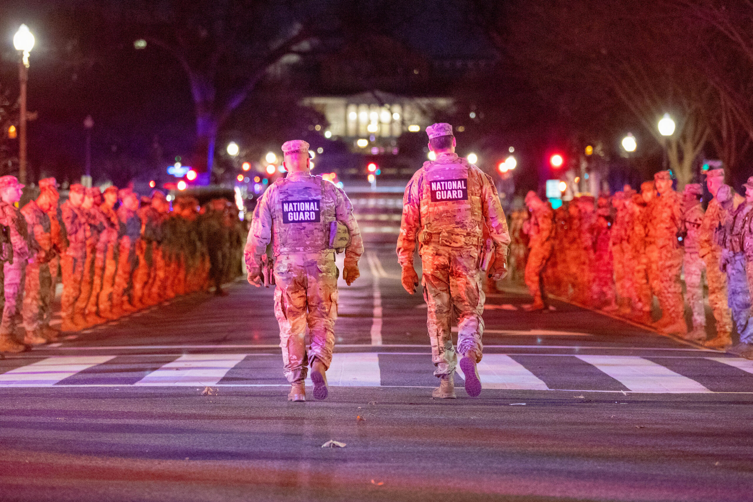 U.S. Army Command Sgt. Maj. Scott McKennon, senior enlisted leader of Joint Task Force–District of Columbia, left, and Col. Larry Doane, the task force’s commander, right, walk down a Soldier-lined street as they prepare to honor U.S. Army Spc. Sarah Beckstrom of the West Virginia National Guard in Washington, D.C., Nov. 27, 2025. A fallen soldier procession was held to pay tribute to Beckstrom’s life and service. (U.S. Army National Guard photo by Sgt. Clay Smith)