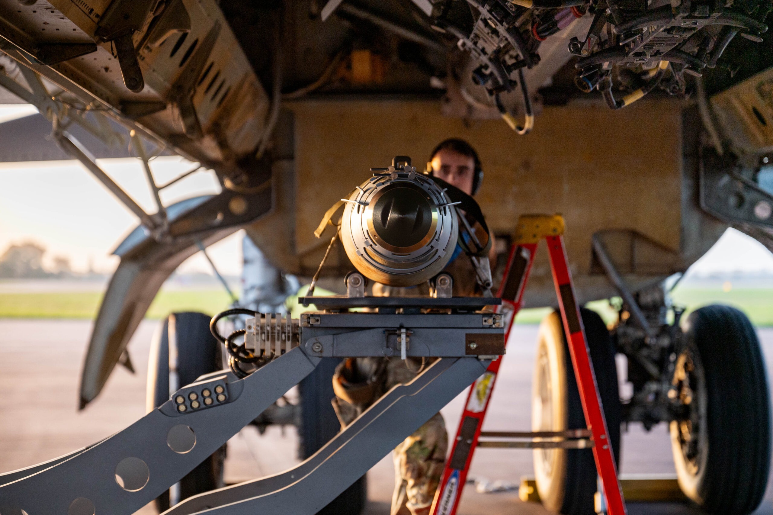 A GBU-38 Joint Direct Attack Munition is prepared to be secured in the bomb bay of a B-52H Stratofortress