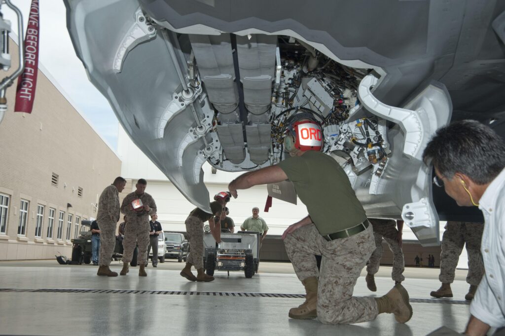 A US soldier arming the GBU 53/B SDB onto a fighter aircraft