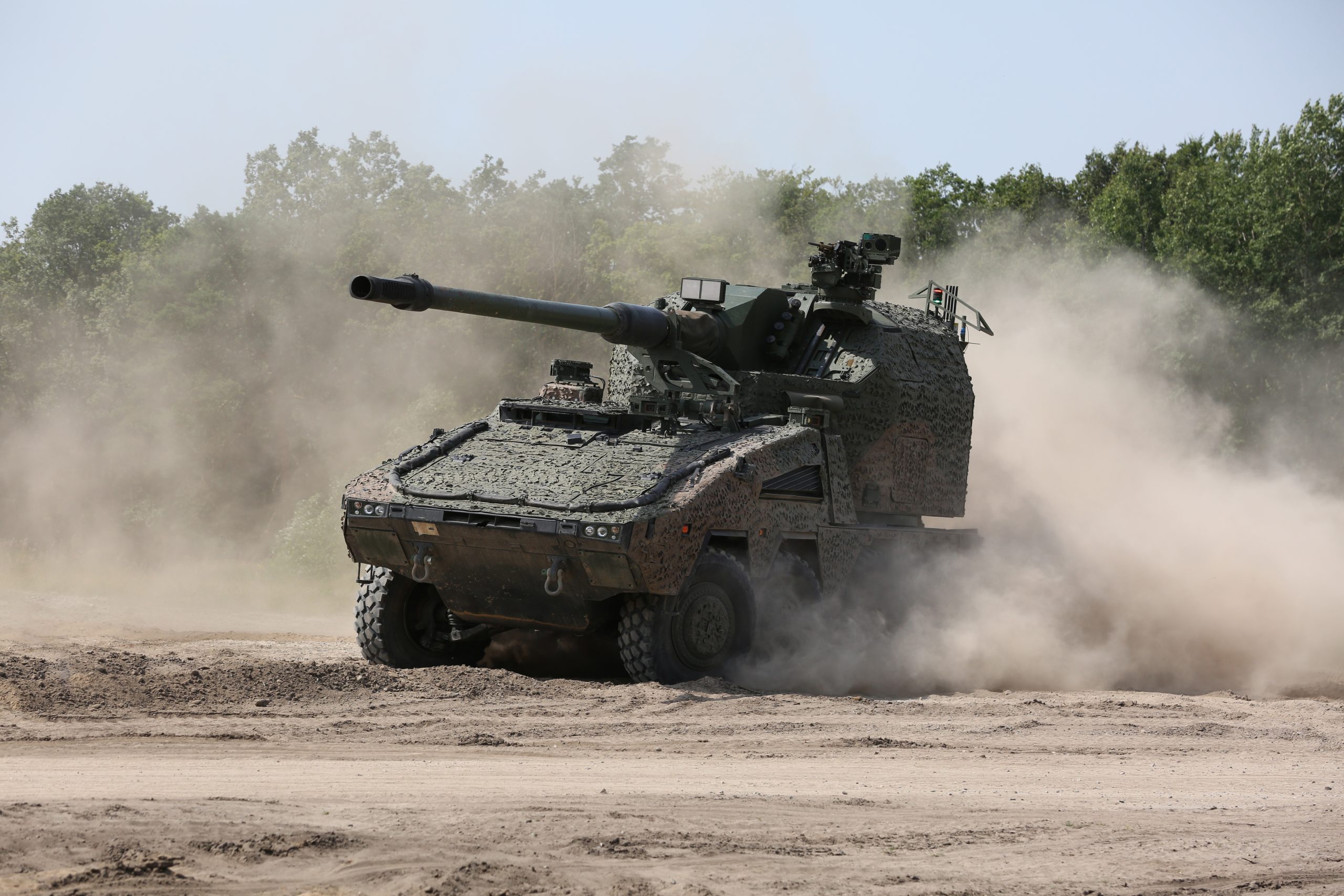 Image of the Remote-Controlled Howitzer 155mm (RCH 155) 52 calibre wheeled artillery system. Seen here at a military training area in Germany. The criticality of artillery fire has never been clearer. Automated artillery systems have packed a powerful punch on the battlefield in Ukraine, and RCH 155 will provide a modernised capability unparalleled in other artillery systems. RCH 155 delivers increased range and accuracy for artillery engagements, a high rate-of-fire of up to nine rounds-per-minute and possesses a powerful blend of tactical and operational mobility. Able to deliver multiple rounds onto a target simultaneously in a 360-degree arc at range, it also has a direct fire capability providing close range defence. As part of the Boxer family, it uses the common Boxer drive module, creating efficiencies in support through platform commonality and modularity, and improving interoperability.