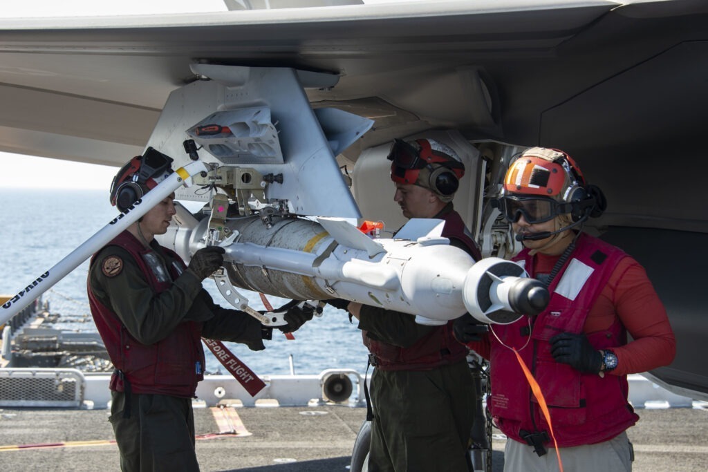US Marines assigned to the “Avengers” of Marine Fighter Attack Squadron (VMFA) 211, load a guided bomb unit (GBU) 49 onto an F-35B Lightning II on the flight deck of Wasp-class amphibious assault ship USS Essex