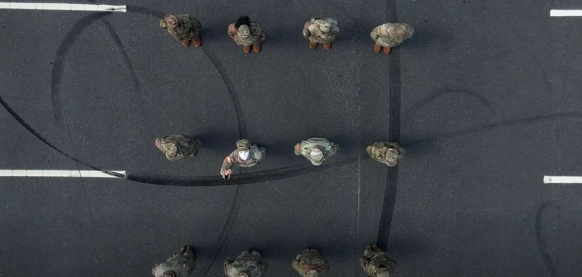 Troops in formation with one soldier wearing a mask. Photo: Staff Sgt. Ashley Sanders/US Army
