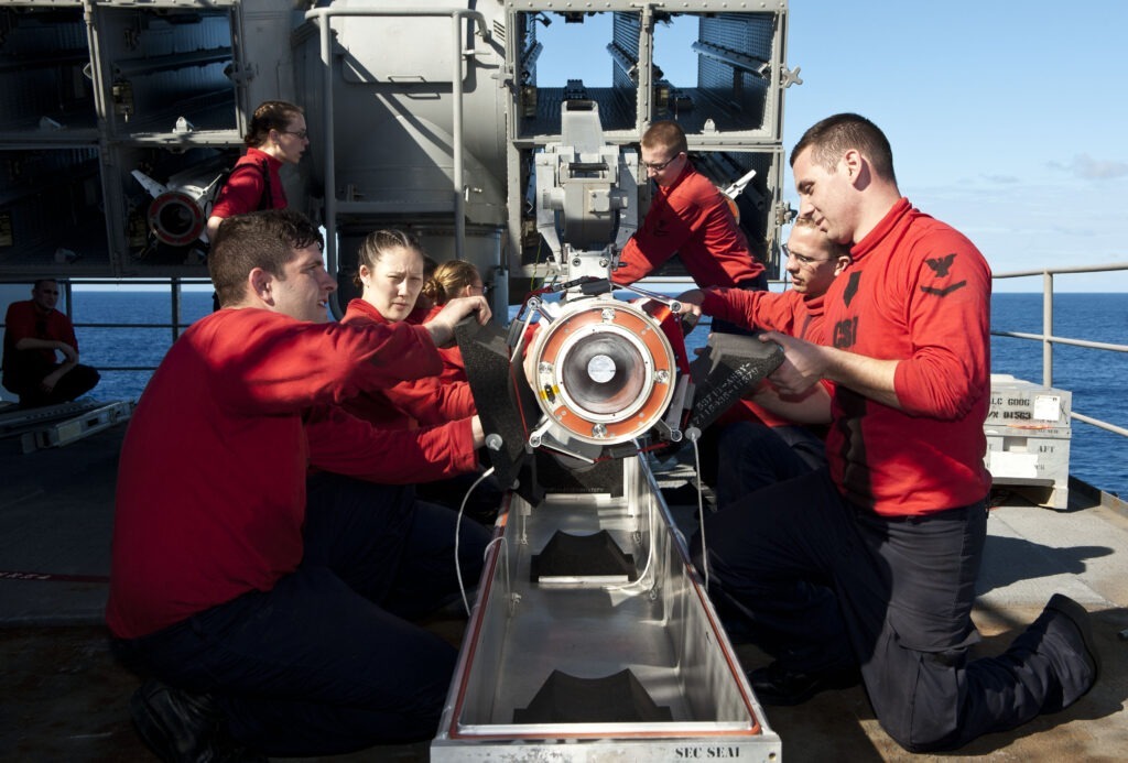 Sailors aboard the Nimitz-class aircraft carrier USS John C. Stennis remove a RIM-7 Sea Sparrow missile from a NATO Sea Sparrow Missile System