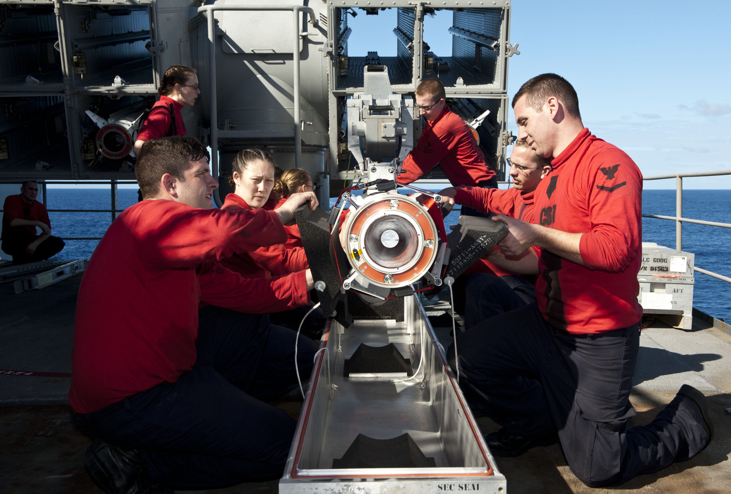 Sailors aboard the Nimitz-class aircraft carrier USS John C. Stennis remove a RIM-7 Sea Sparrow missile from a NATO Sea Sparrow Missile System