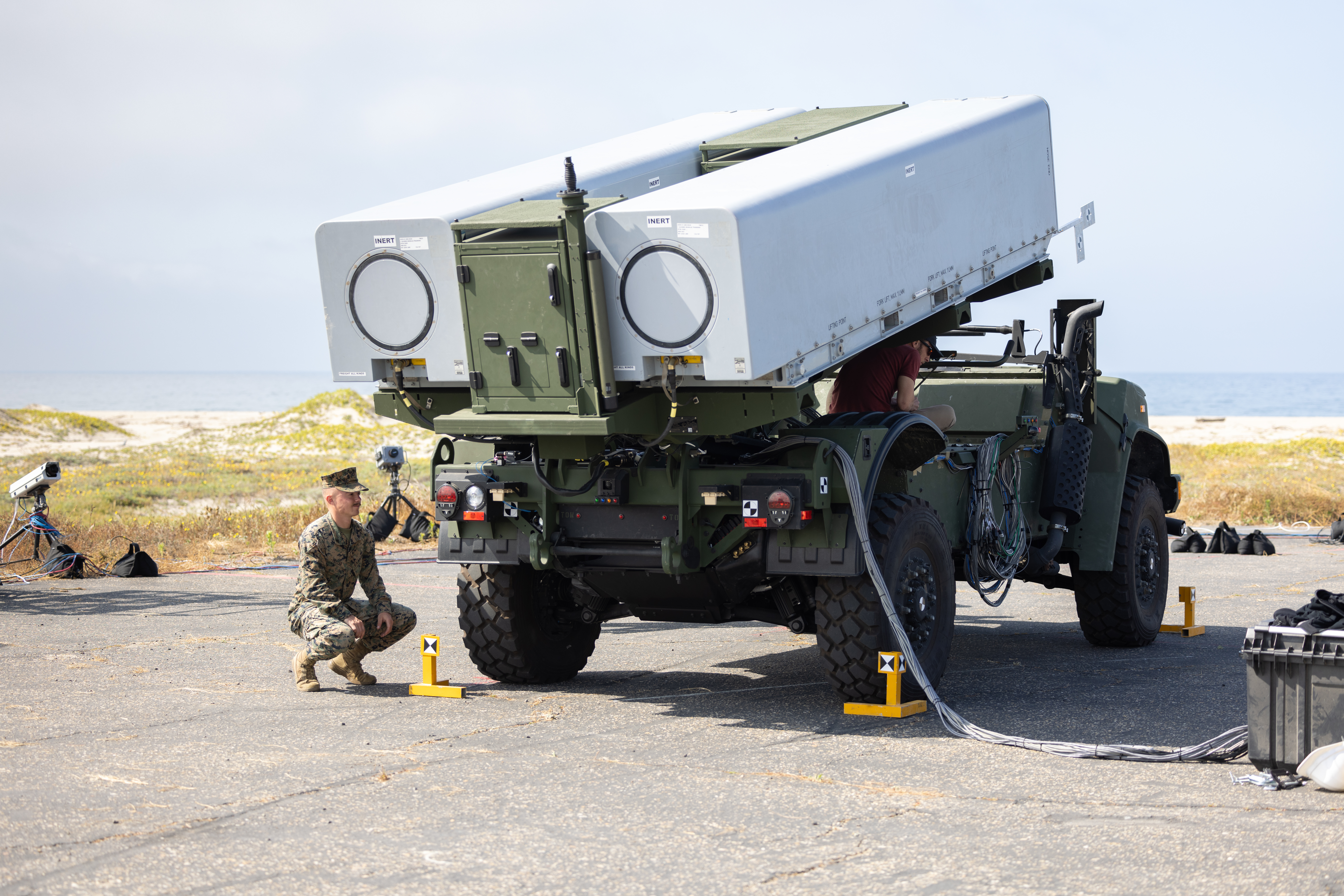 An artillery cannoneer prepares a Navy/Marine Expeditionary Ship Interdiction System to be fired at Naval Air Station Point