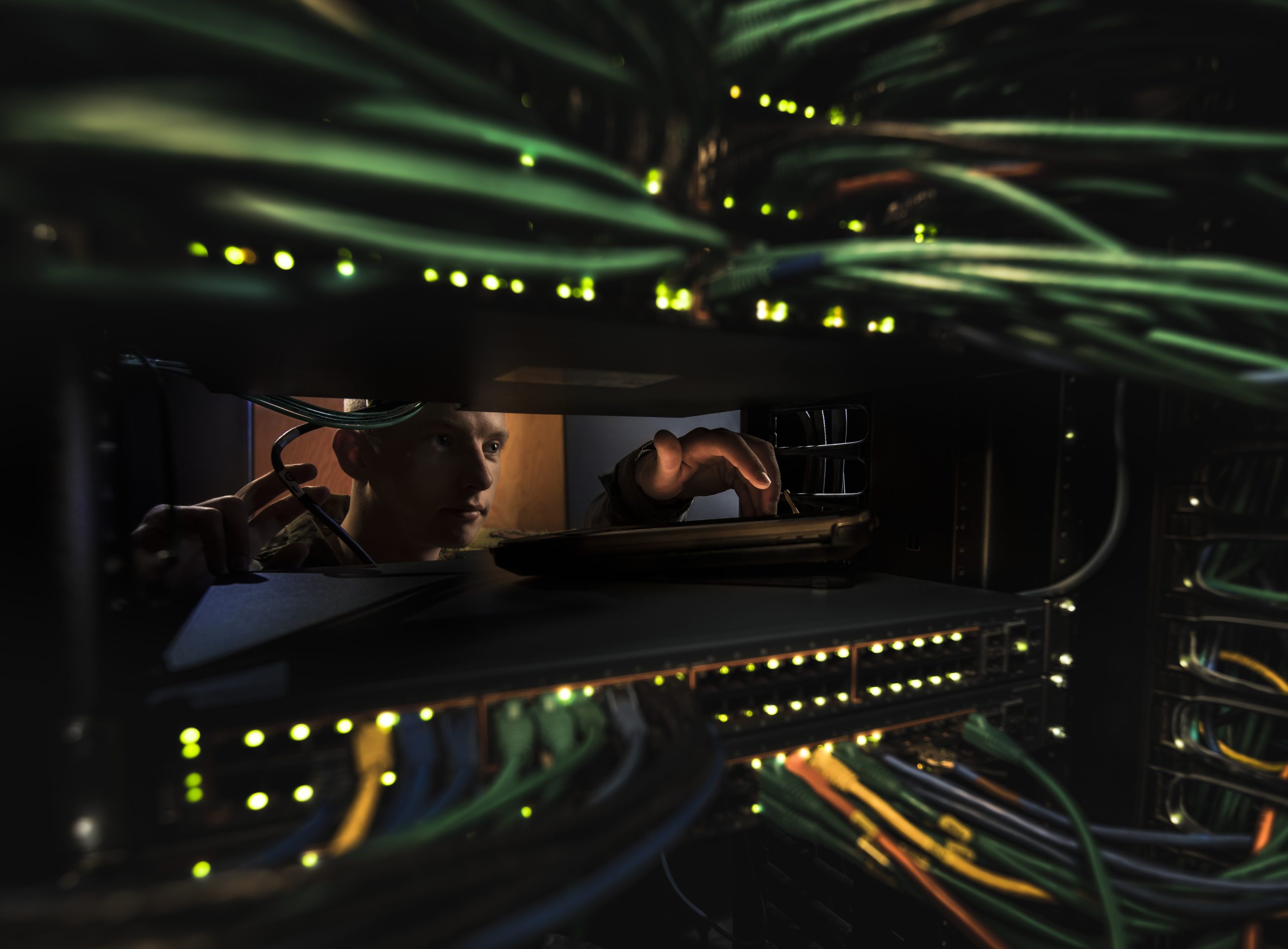 Airman 1st Class Thomas Schoening, a Cyber Transport Systems airman, poses for a photograph in the server room at the 153d Airlift Wing, Wyoming Air National Guard Base, Cheyenne, Wyo., Nov. 1, 2019. (U.S. Air National Guard photo by Staff Sgt. Jon Alderman)