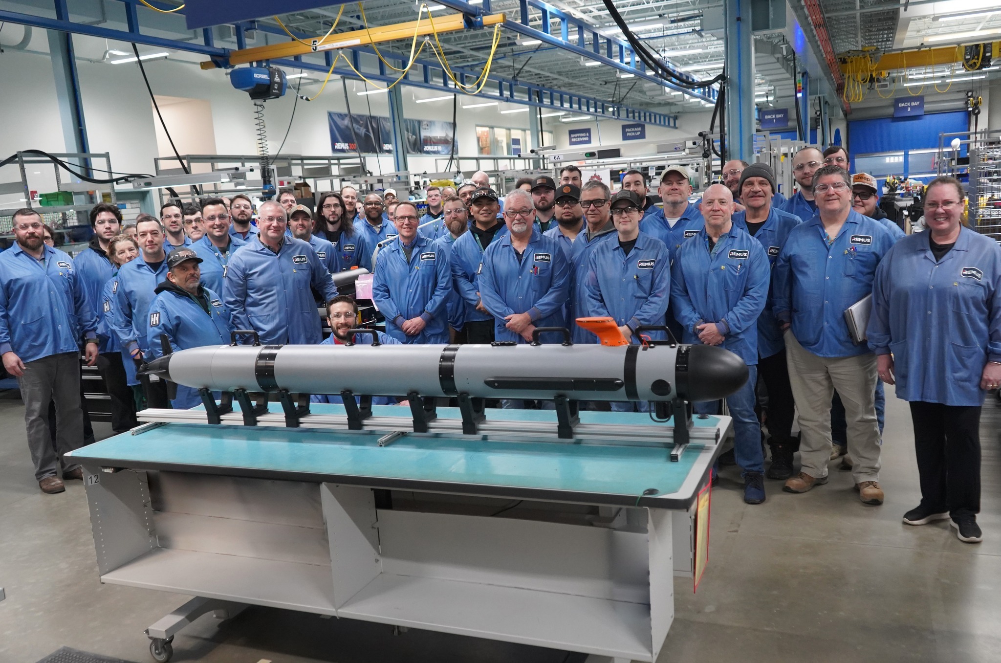 HII engineers and technicians celebrate the completion of the 42nd Lionfish small unmanned underwater vehicle (SUUV) for the U.S. Navy at the company’s unmanned production facility in Pocasset, Massachusetts.