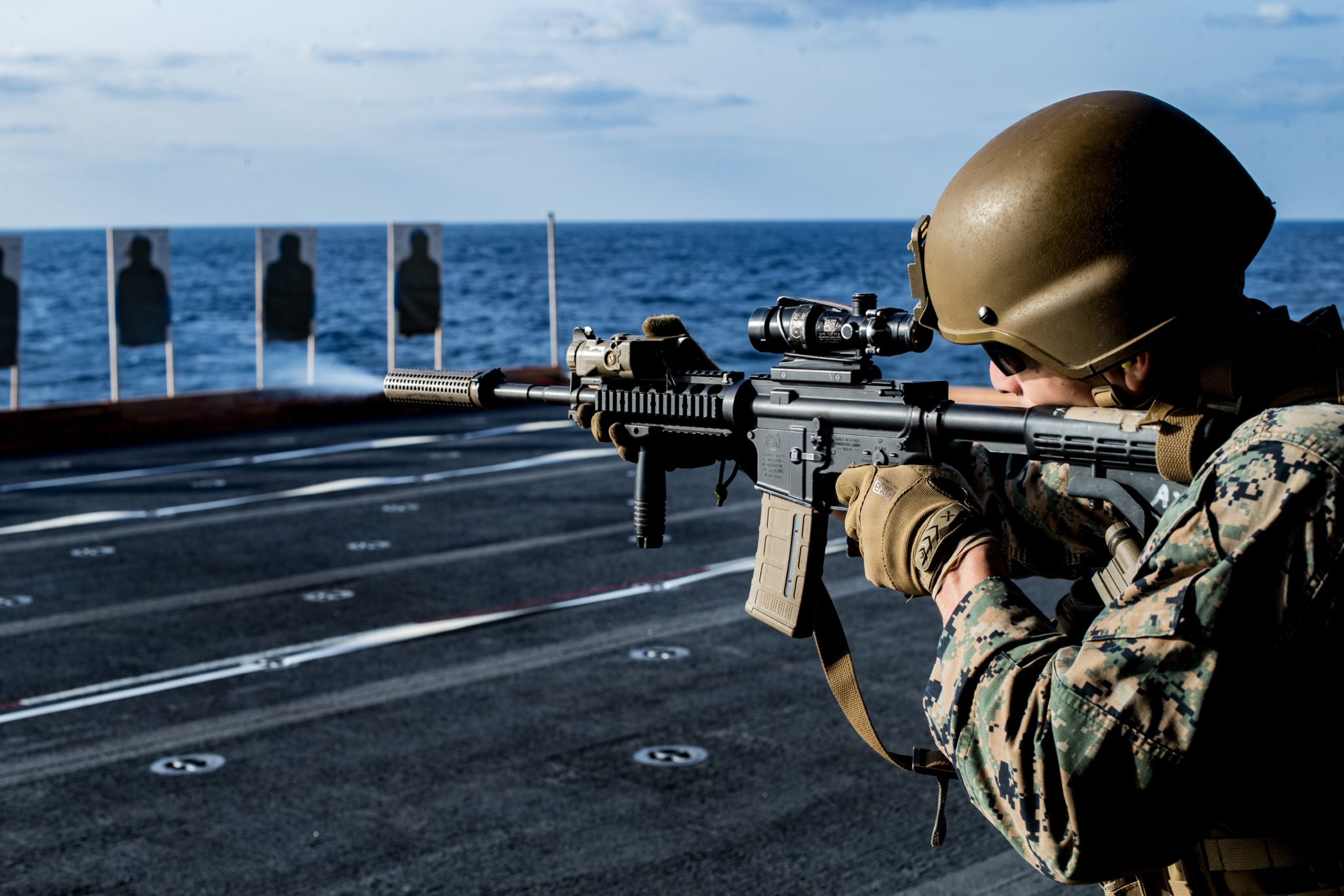 PHILIPPINE SEA (April 3, 2020) A Marine with Battalion Landing Team, 1st Battalion, 5th Marines, 31st Marine Expeditionary Unit (MEU), fires his M4A1 service rifle during a combat marksmanship range aboard amphibious assault ship USS America (LHA 6). Deck shoots allow Marines to get hands on training with their rifles to ensure that they stay proficient and lethal with their weapon systems. America, flagship of the America Expeditionary Strike Group, 31st MEU team, is operating in the U.S. 7th Fleet area of operations to enhance interoperability with allies and partners and serve as a ready response force to defend peace and stability in the Indo-Pacific region. (U.S. Marine Corps photo by Lance Cpl. Kolby Leger)