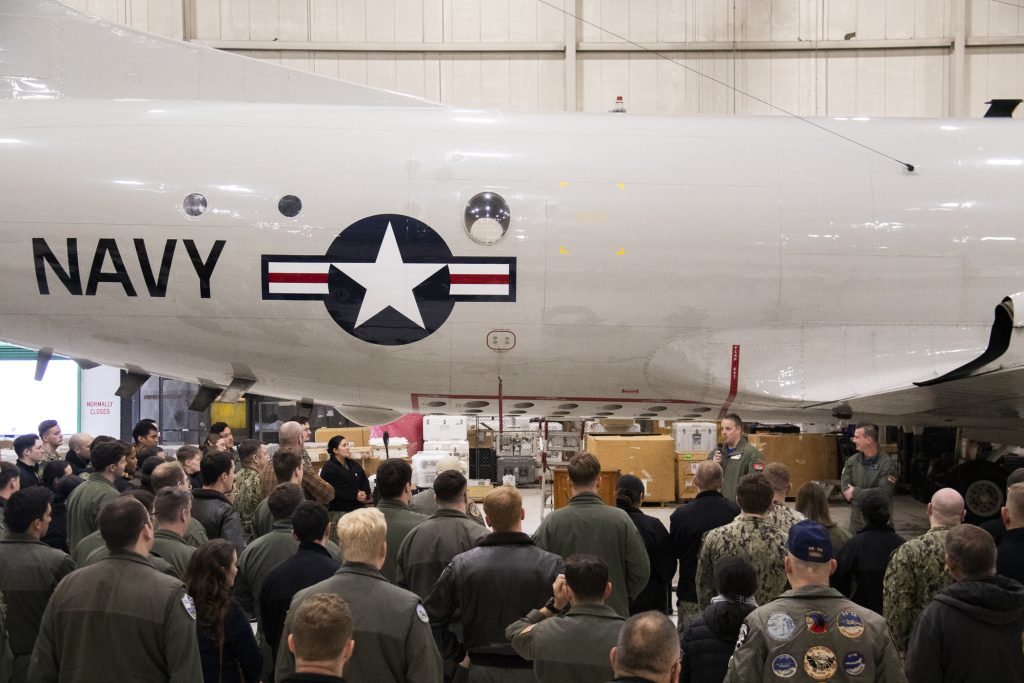 Patrol Squadron (VP) 9, shares stories about flying the P-3C Orion to Sailors and members of the public during a sundowning ceremony 