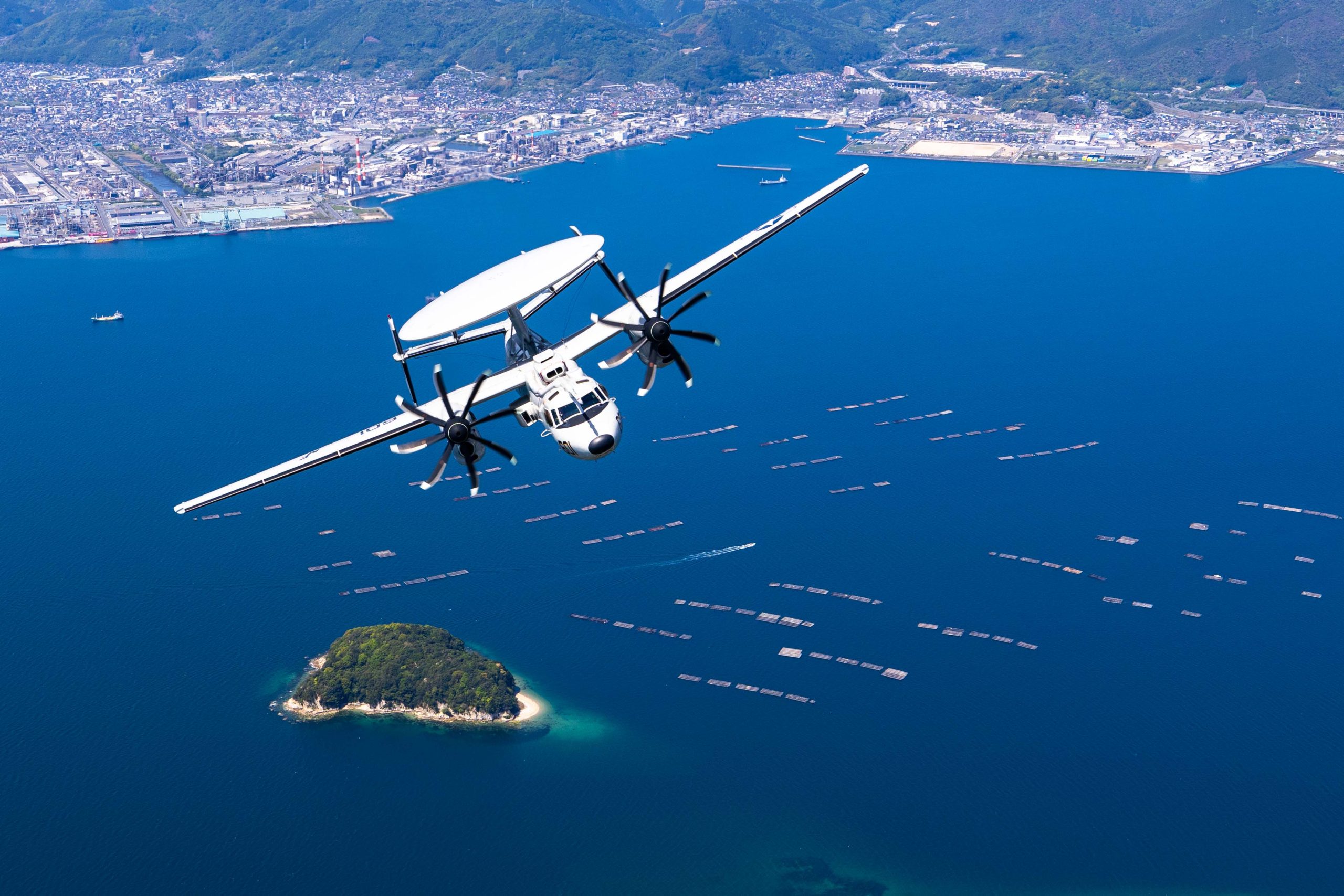 250504-N-KW492-1541 IWAKUNI, Japan (May 4, 2025) - An E-2D Hawkeye assigned to Airborne Command and Control Squadron (VAW) 125, Carrier Air Wing (CVW) 5, flies over Iwakuni, Japan during Marine Corps Air Station Iwakuni’s 46th Friendship Day at MCAS Iwakuni, Japan, May 4, 2025. Since 1973, MCAS Iwakuni has held a Friendship Day open house to foster positive relationships between the air station and its Japanese hosts, offering a culturally enriching experience that displays the mutual support between the U.S. and Japan. CVW-5 is the U.S. Navy’s only permanently forward deployed air wing and consists of nine squadrons flying F-35C Lightning II, F/A-18E/F Super Hornets, EA-18G Growlers, E-2D Hawkeyes, CMV-22B Ospreys and MH-60R/S Sea Hawks used to conduct carrier air warfare operations and assist in the planning, control, coordination and integration of air wing squadrons in support of carrier air warfare. (U.S. Navy photo by Mass Communication Specialist 1st Class Ryre Arciaga)