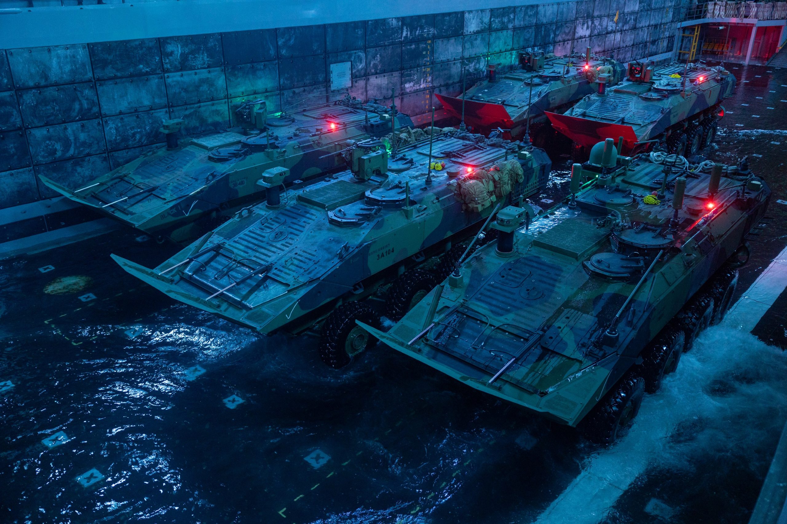 U.S. Marine Corps amphibious combat vehicles with 3rd Assault Amphibian Battalion, 1st Marine Division, stage for debarkation in the well deck of San Antonio-class amphibious transport dock ship USS Portland (LPD 27) during rehearsals for the 250th Birthday Amphibious Capabilities Demonstration off the coast of Marine Corps Base Camp Pendleton, California, Oct. 15, 2025. The Marine Corps 250th Birthday Amphibious Capabilities Demonstration is one of many events taking place across the country to showcase the Navy–Marine Corps team’s ability to project power from the sea and defend the Nation. For 250 years, Marines have been America’s expeditionary force-in-readiness — capable, credible, and committed to winning the Nation’s battles. (U.S. Marine Corps photo by Cpl. Avery Wayland)
