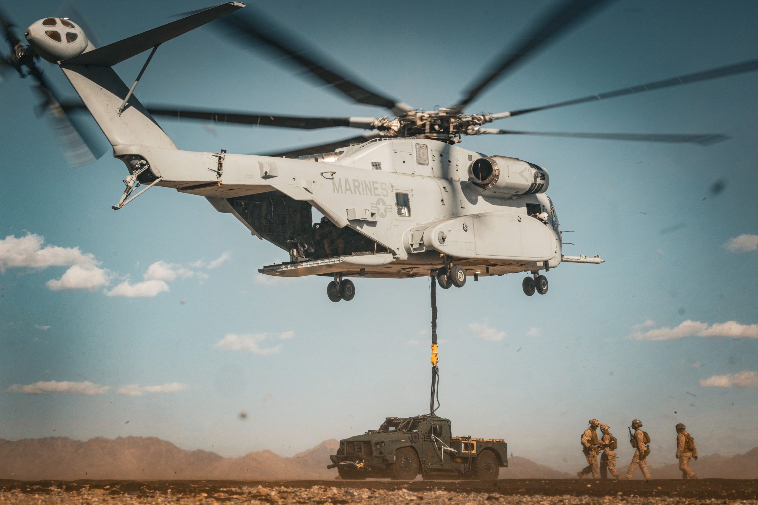 U.S. Marine Corps CH-53K King Stallion aircraft assigned to Marine Aviation Weapons and Tactics Squadron One (MAWTS-1) lifts a Joint Light Tactical Vehicle during a heavy lift exercise as part of Weapons and Tactics Instructor course 1-26 at near Marine Corps Air Station, Yuma, Arizona, Sept. 30, 2025. WTI is a seven-week training event hosted by MAWTS-1 which emphasizes operational integration of the six functions of Marine aviation in support of the Marine Air Ground Task Force, Joint and Coalition Forces. (U.S. Marine Corps photo by Lance Cpl. Fabian Ortiz)