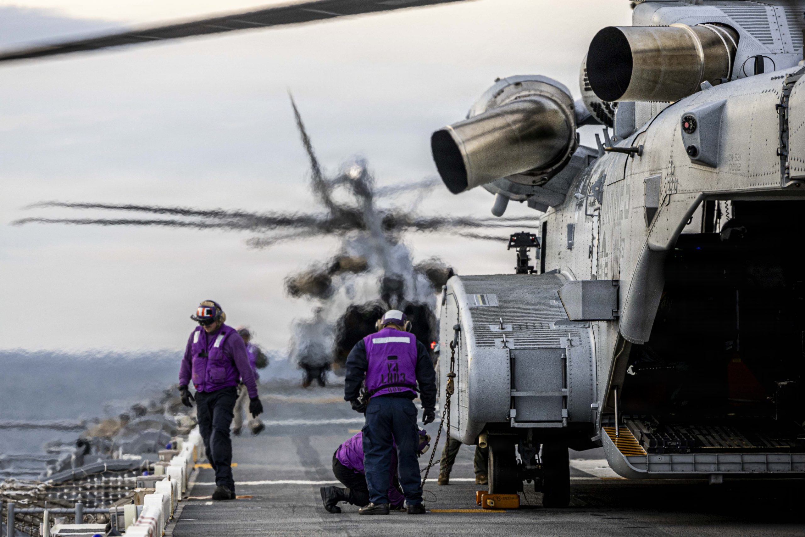 251204-N-EG735-1437 ATLANTIC OCEAN – (Dec. 4, 2025) Sailors, assigned to the Wasp-class amphibious assault ship USS Kearsarge (LHD 3), re-fuel a CH-53K King Stallion, assigned to U.S. Marine Heavy Helicopter Squadron (HMH) 461, during flight operations, Dec. 4, 2025. Kearsarge is currently underway conducting Basic phase certifications. Photo was edited for operational security. (U.S. Navy photo illustration by Mass Communication Specialist Seaman Apprentice Chase McDaniel)