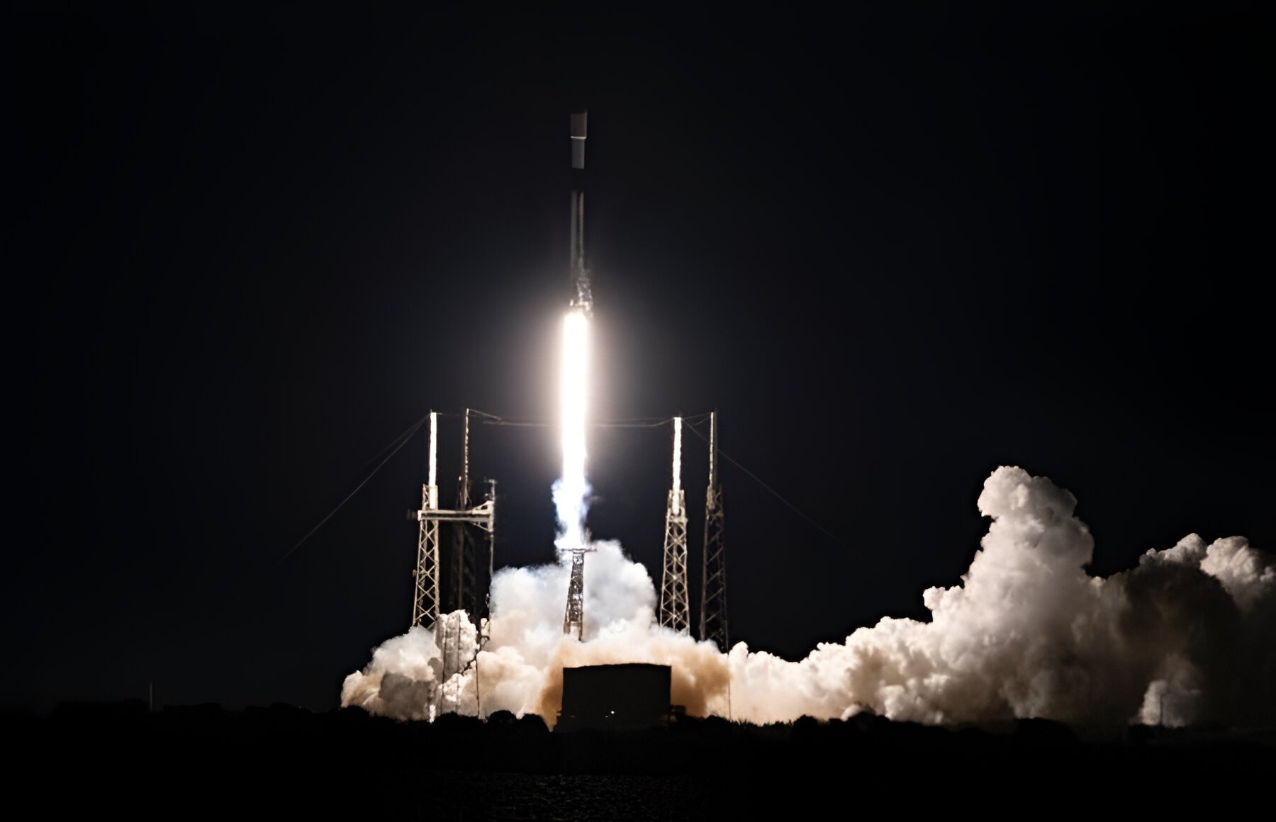 A GPS 3 SV09 launching from a rocket during the nighttime. Smoke is visible.