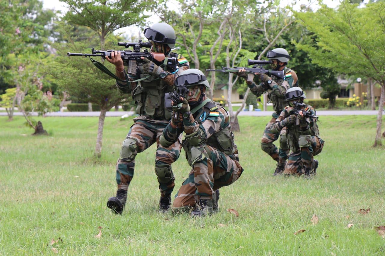 Soldiers in camouflage from the India practice shooting at a target, demonstrating precision and focus.